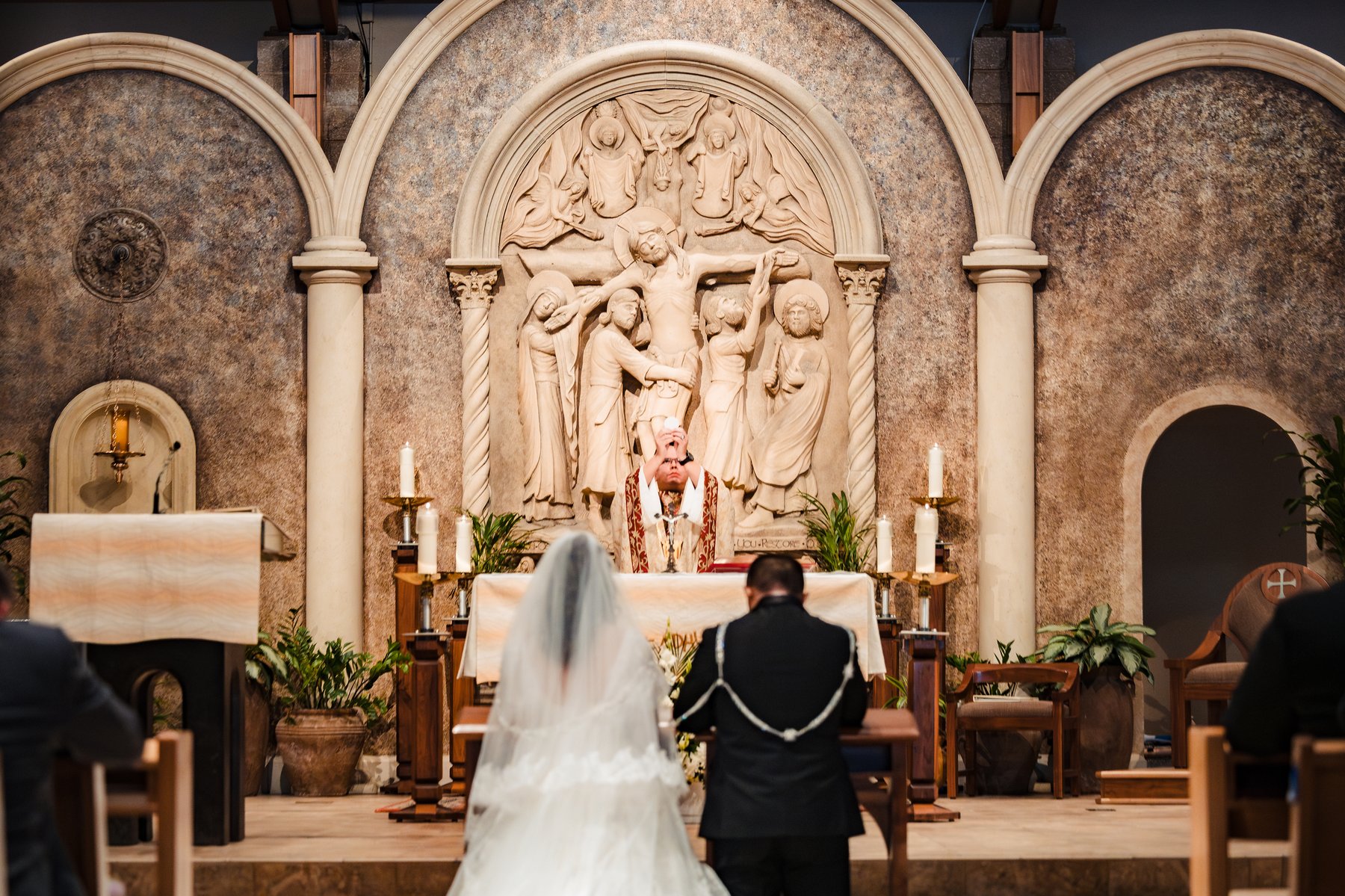 The elevation of the host during the Catholic wedding Mass at St. Martha's, Murrieta