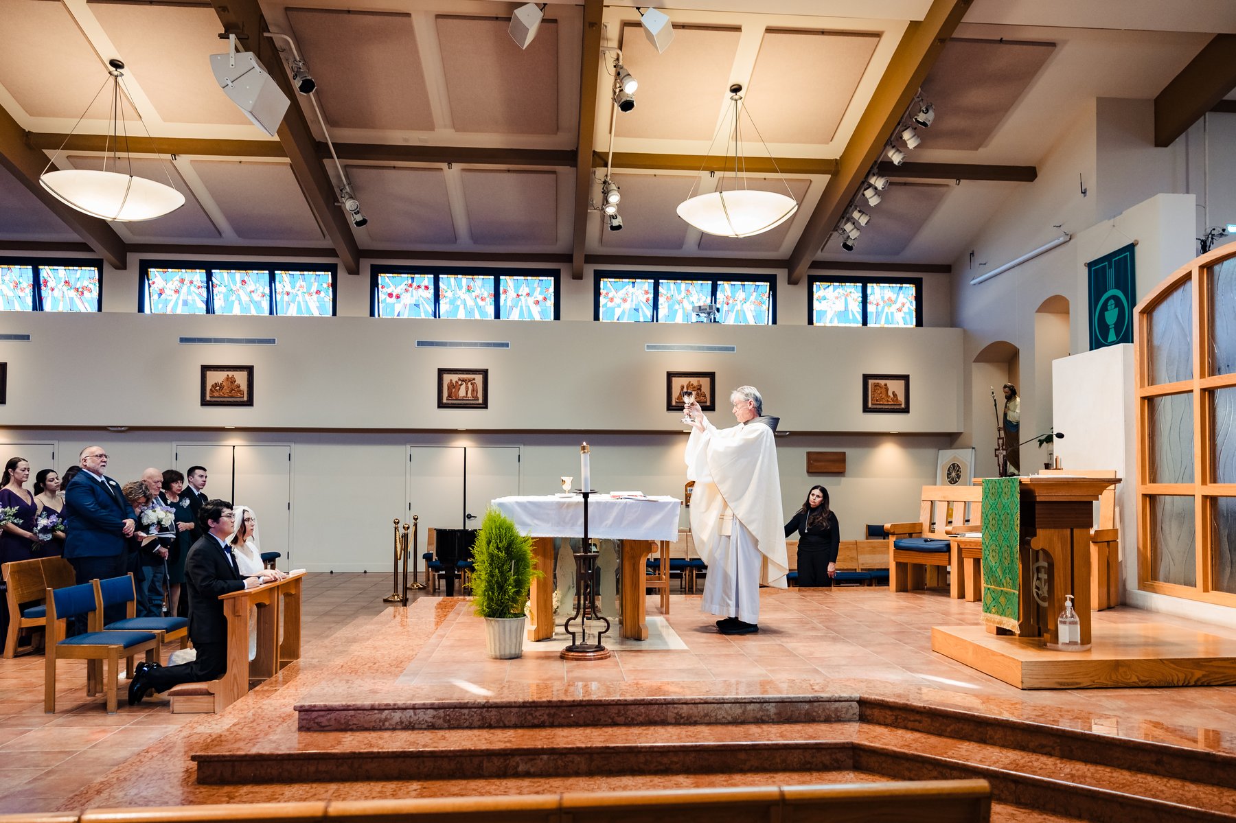 Catholic wedding at Our Lady of Guadalupe in Hermosa Beach during the elevation of the chalice