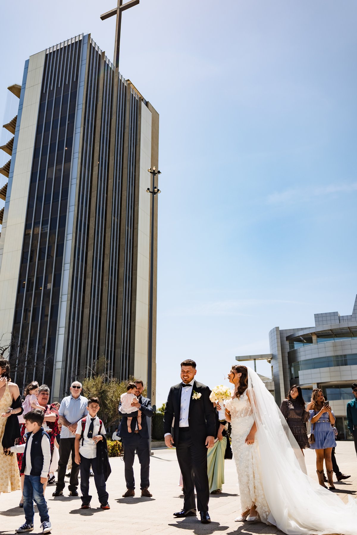 The married couple outside Christ Cathedral with the iconic cross tower of the Diocese of Orange