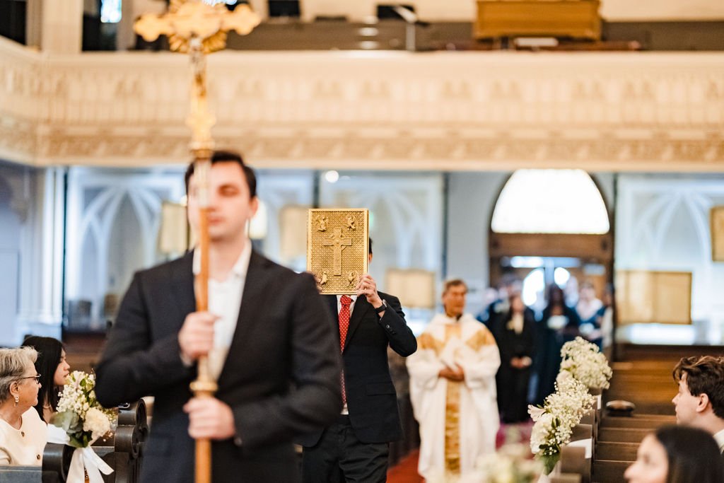 Cross-bearer and Book of the Gospels leading the entrance procession at Old St. Mary's Cathedral
