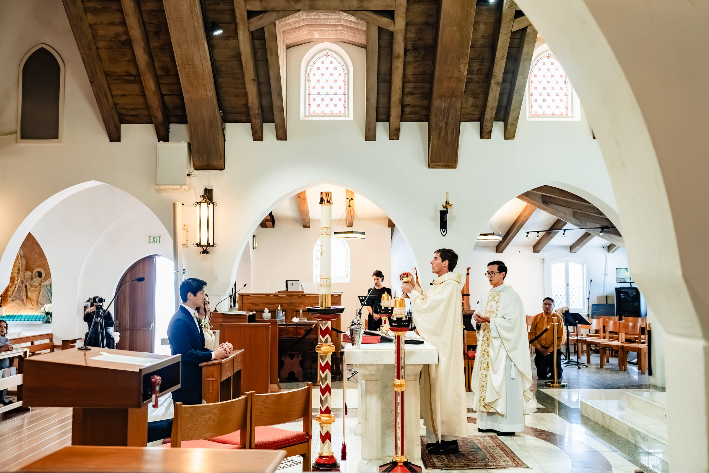 Matthew and Maya's Catholic wedding at St. Mary's Star of the Sea in La Jolla — the sanctuary during the Nuptial Mass
