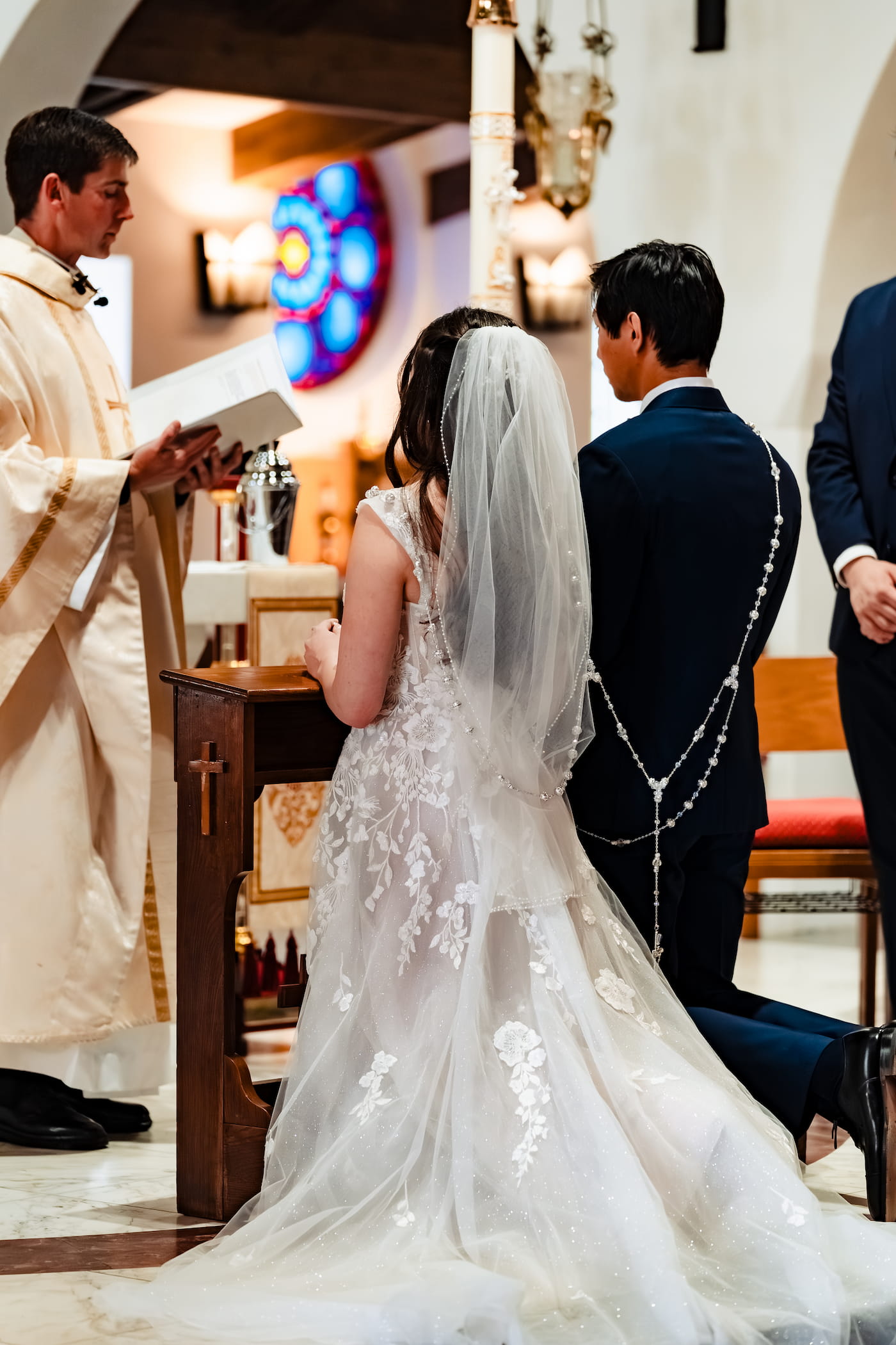 Matthew and Maya's Catholic wedding at St. Mary's Star of the Sea in La Jolla — the consecration during the Catholic wedding Mass