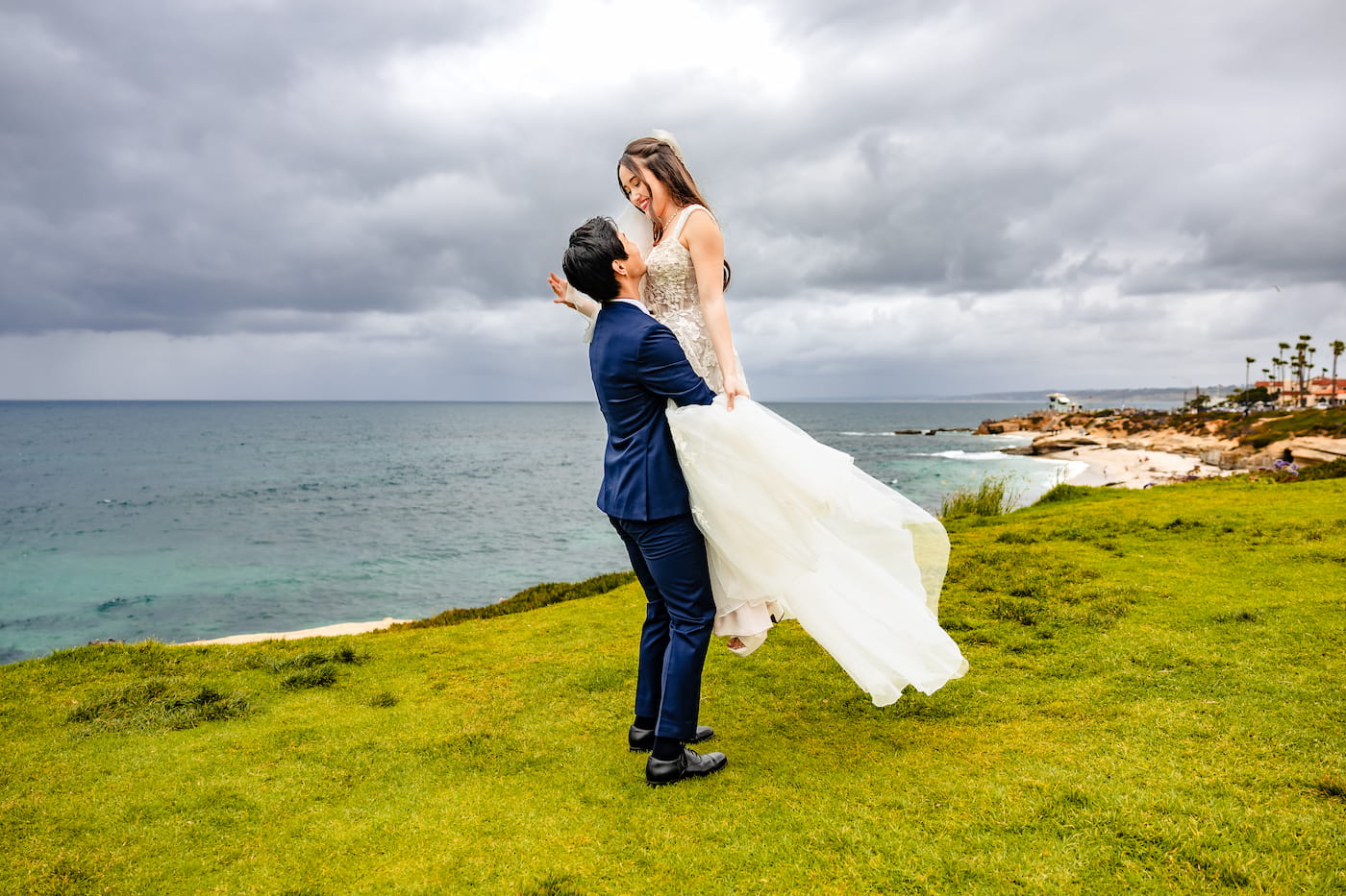 Matthew and Maya's Catholic wedding at St. Mary's Star of the Sea in La Jolla — wedding portrait above the Pacific