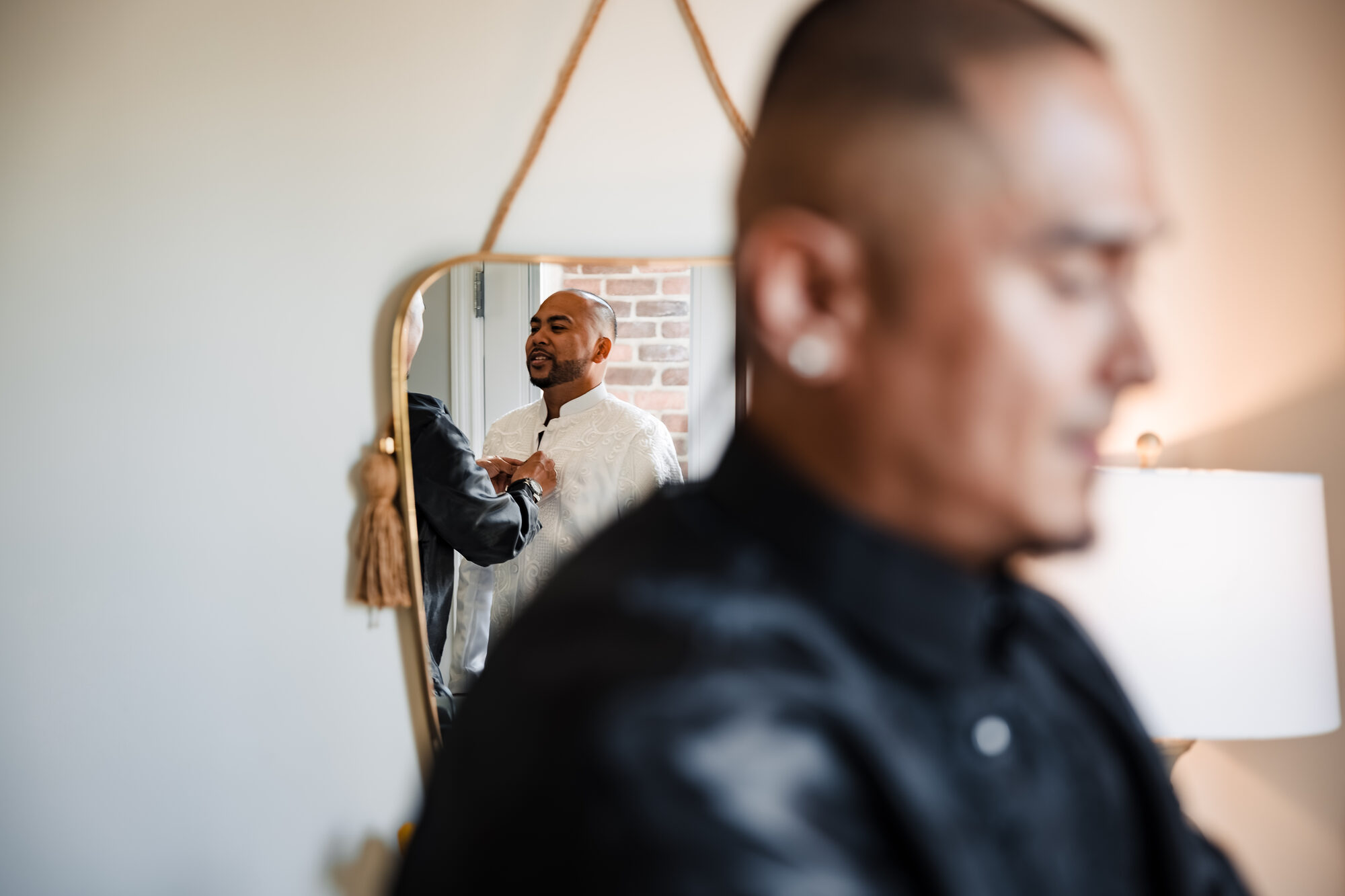 Groom getting ready before his Catholic wedding at Hotel Winters in Winters, California