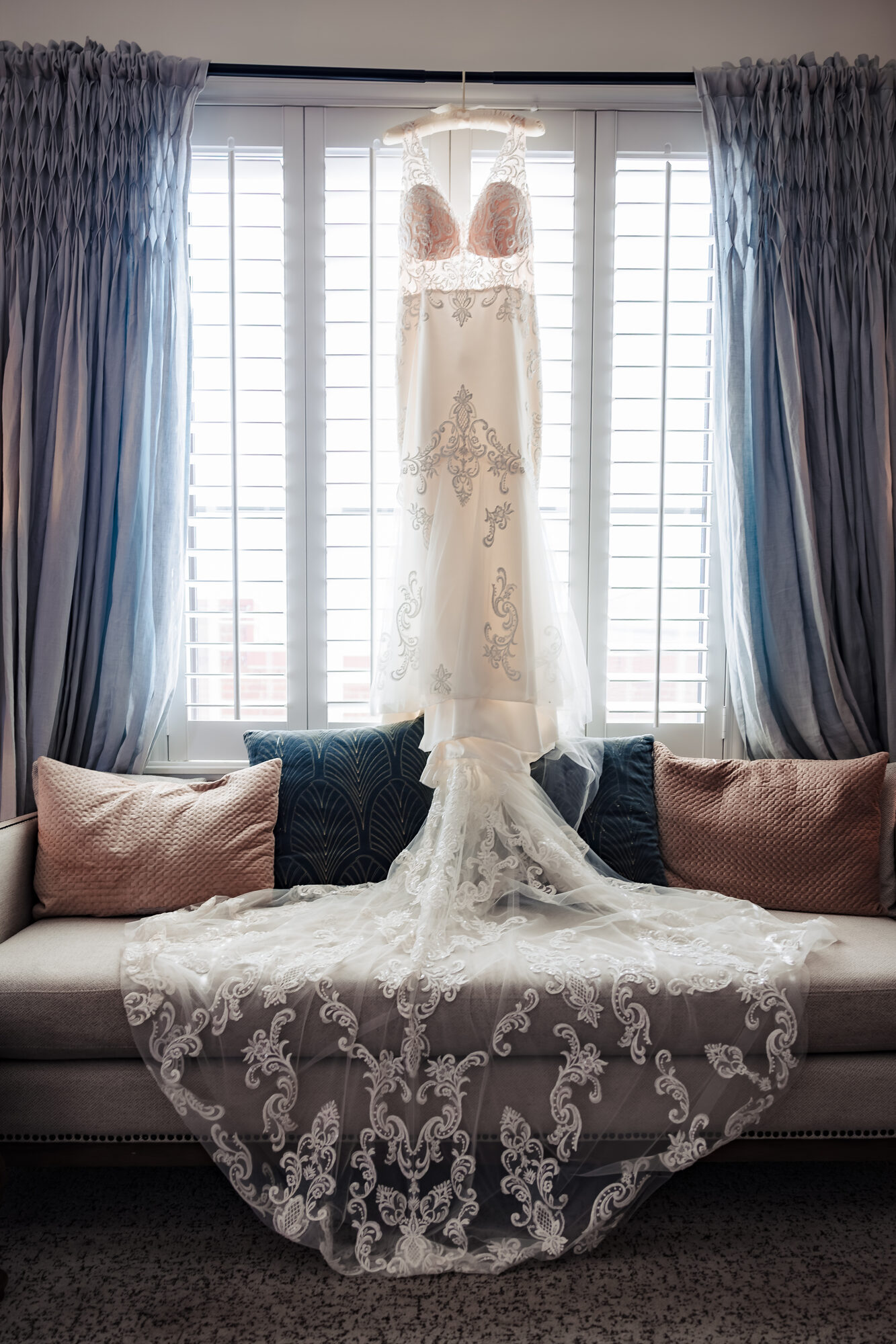 Wedding dress hanging before a Catholic wedding at Hotel Winters