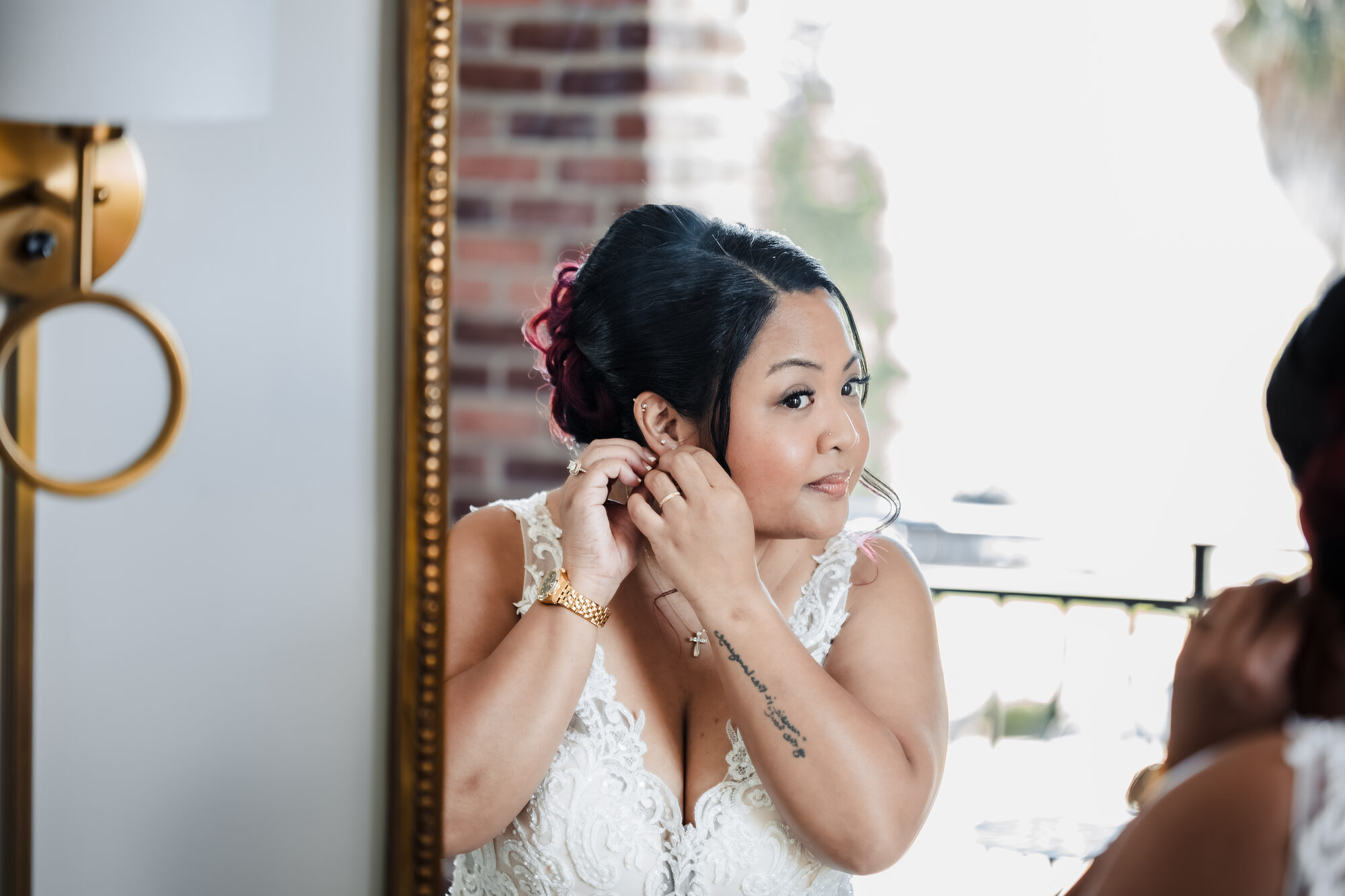 Bride getting her earrings on before her Catholic wedding in Winters