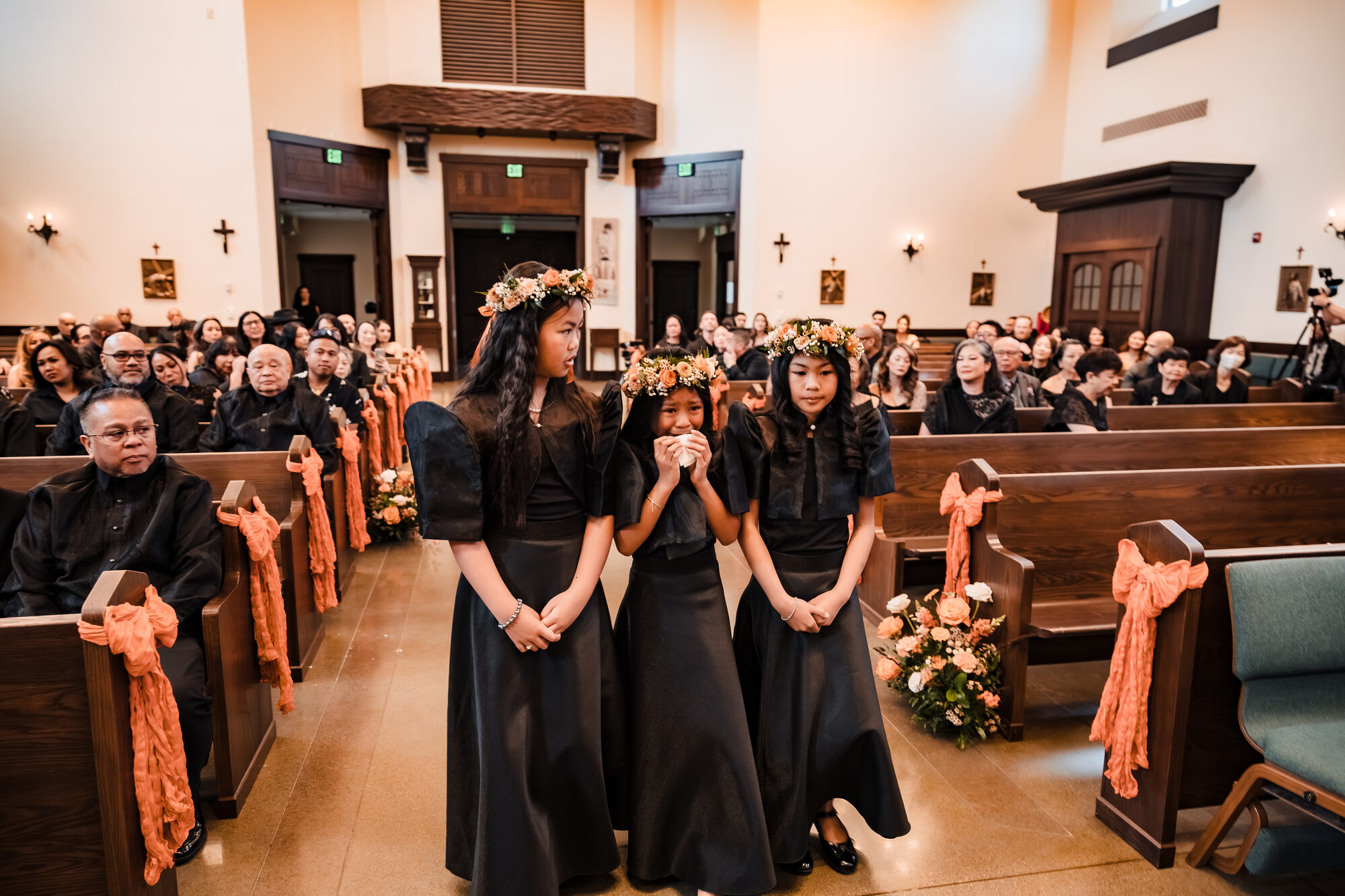 Flower girls walking down the aisle at a Catholic wedding in Winters, California