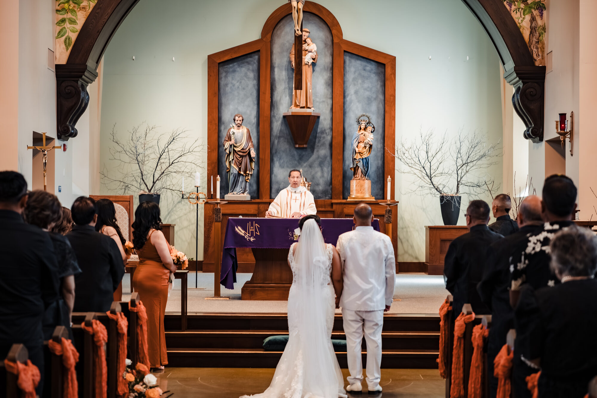 Priest celebrating the nuptial Mass at a Catholic wedding in Winters, California