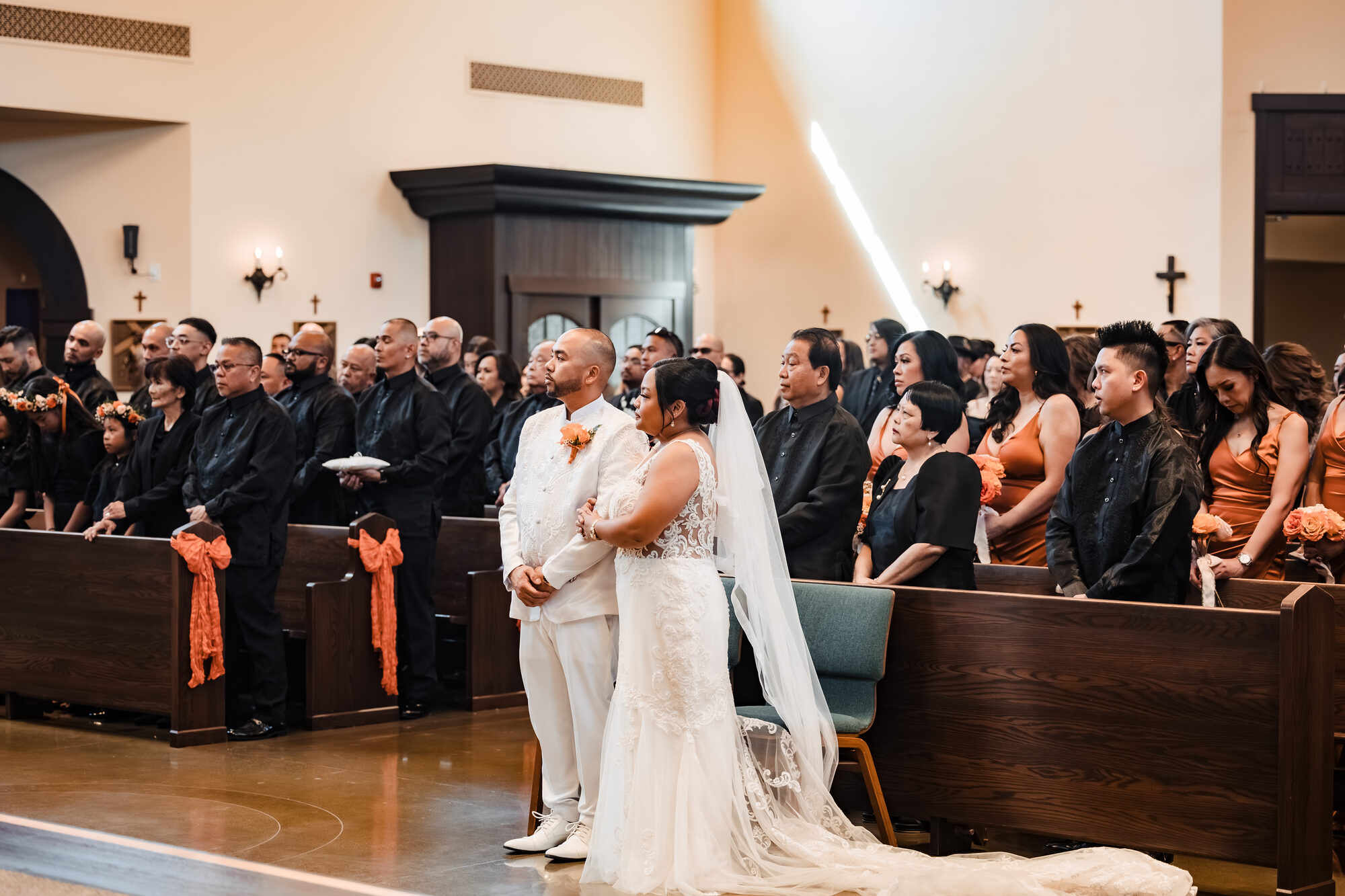 Bride and groom standing before the priest during their Catholic wedding Mass