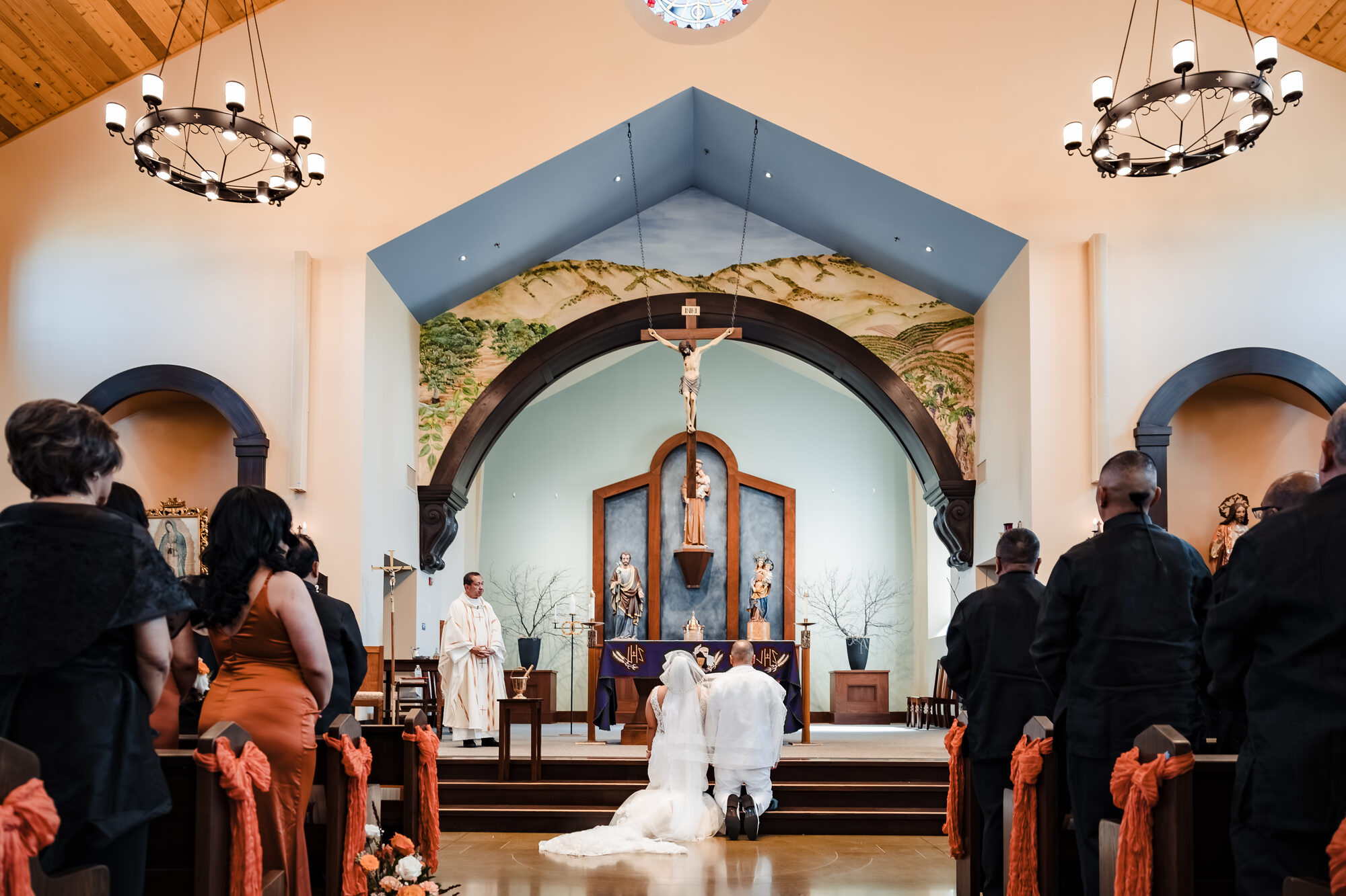 Bride processing into the church on her father's arm during a Catholic wedding
