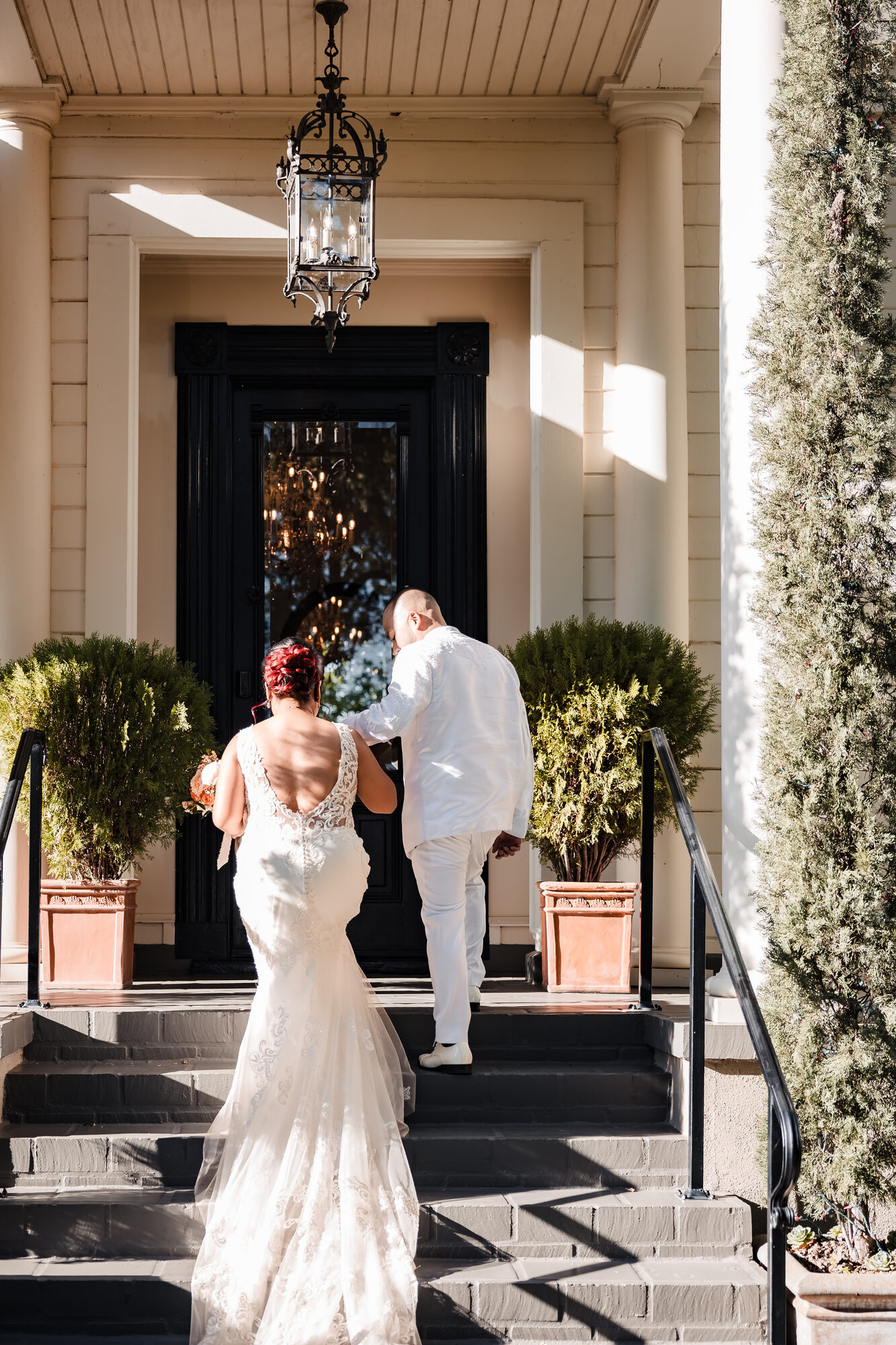 Bride and groom climbing the steps of the Park Winters mansion