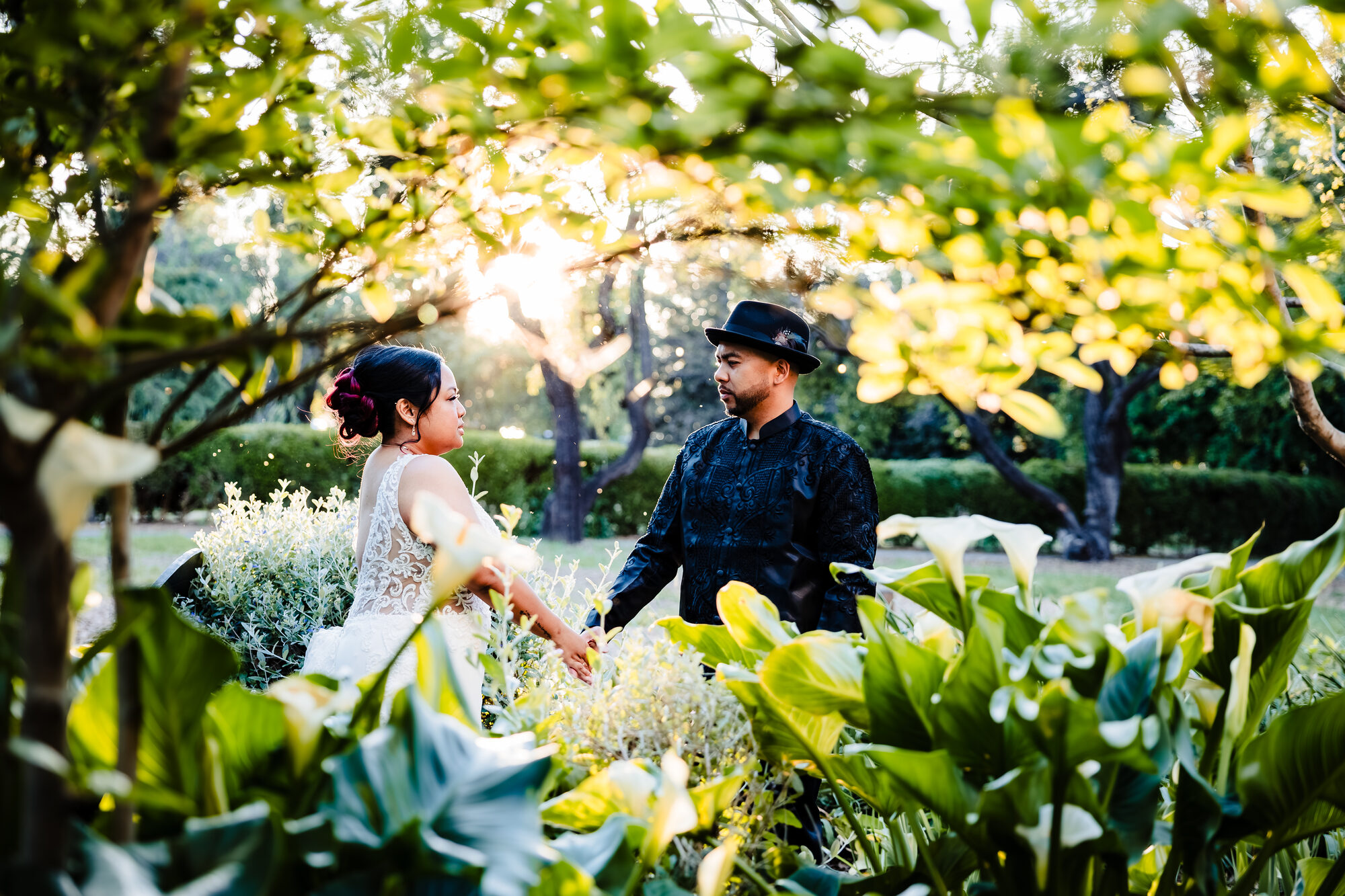 Bride and groom holding hands in the garden at sunset, Park Winters