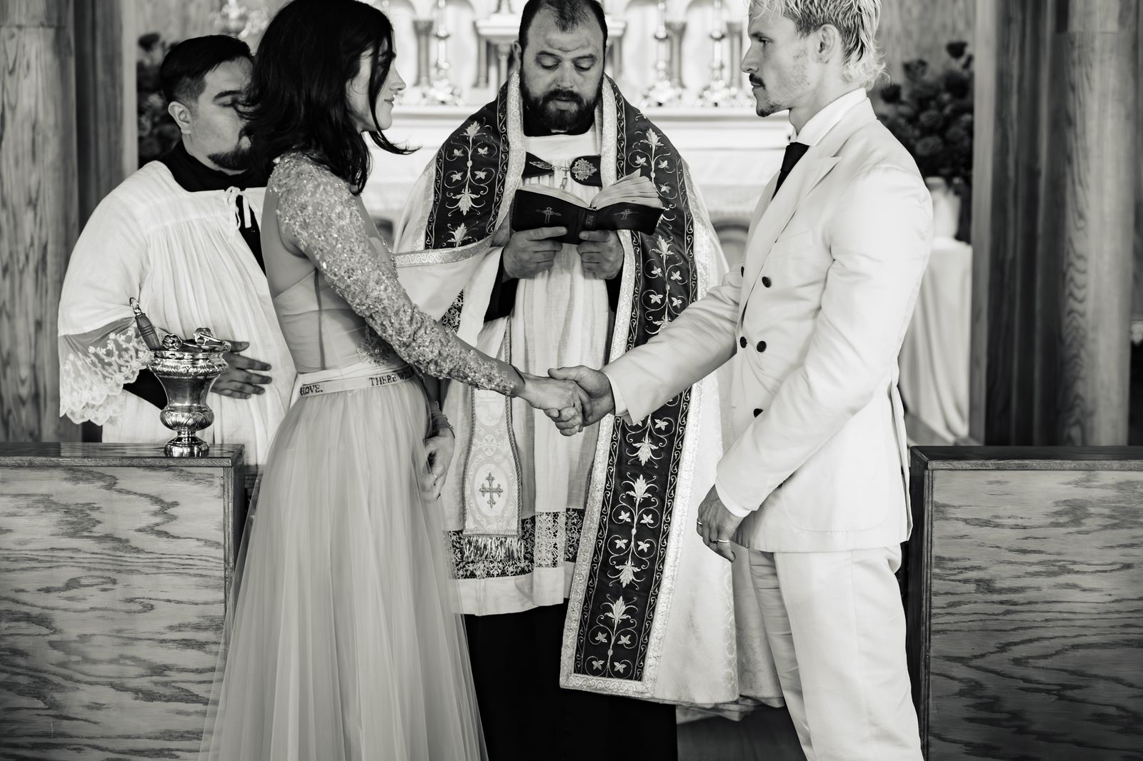 A couple at the altar during their Catholic convalidation, in black and white