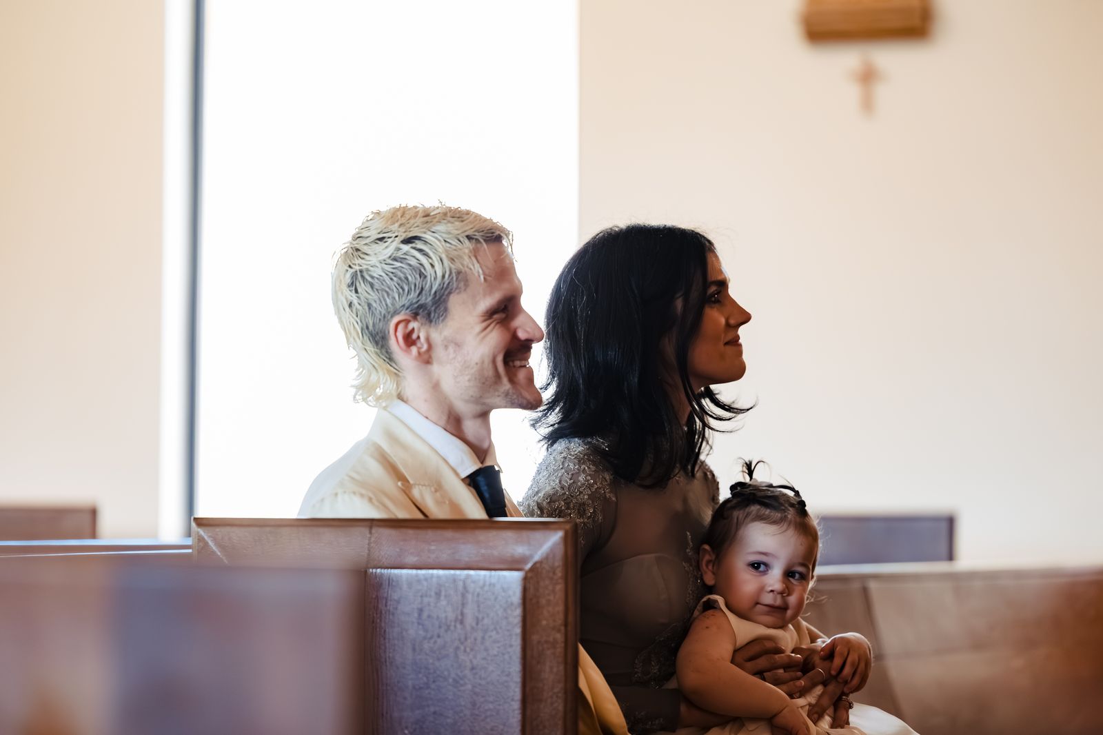 A couple with their young child in the pew during their Catholic convalidation