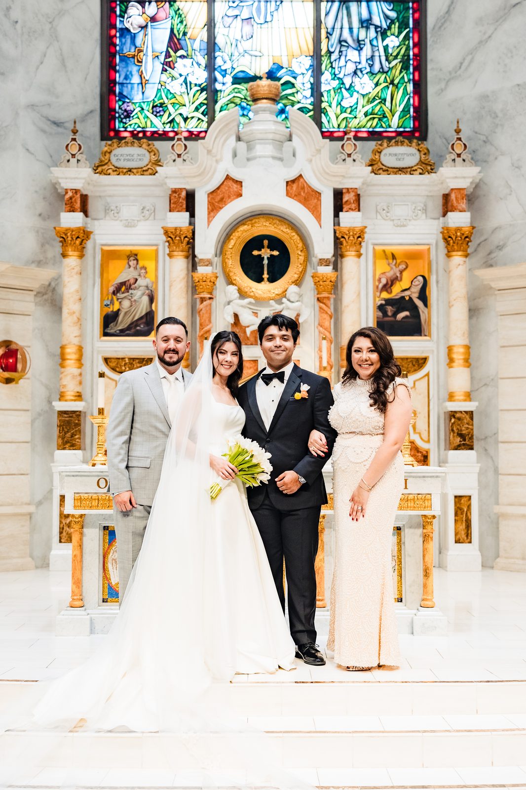 A bride and groom with their padrinos from their community at the altar