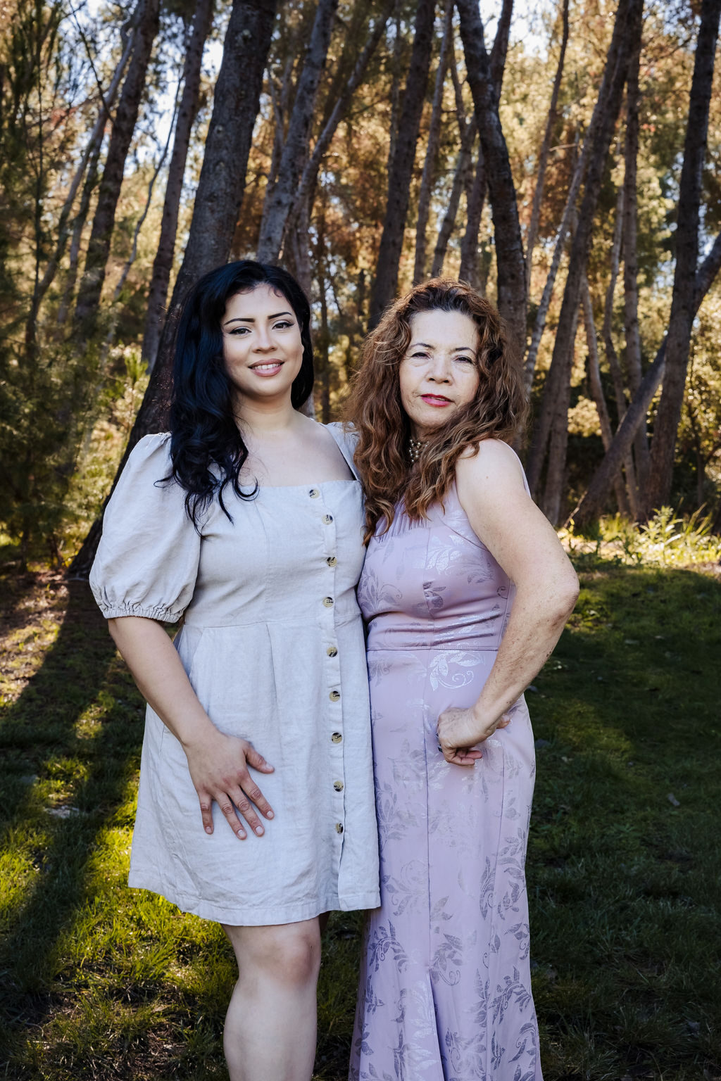 A mother and adult daughter portrait among the trees