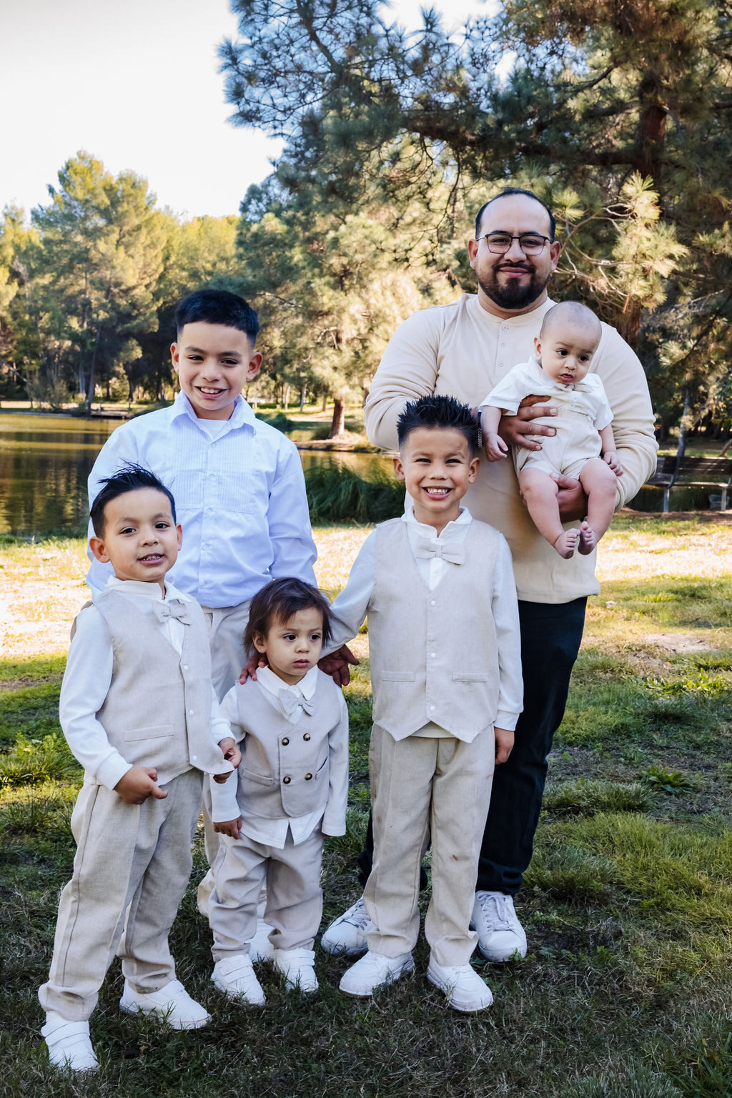 A father with his sons and infant, full family portrait