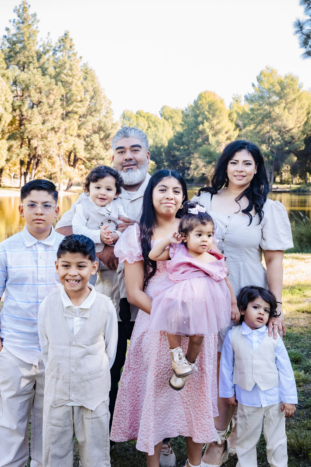 A large extended family portrait of three generations by a lake