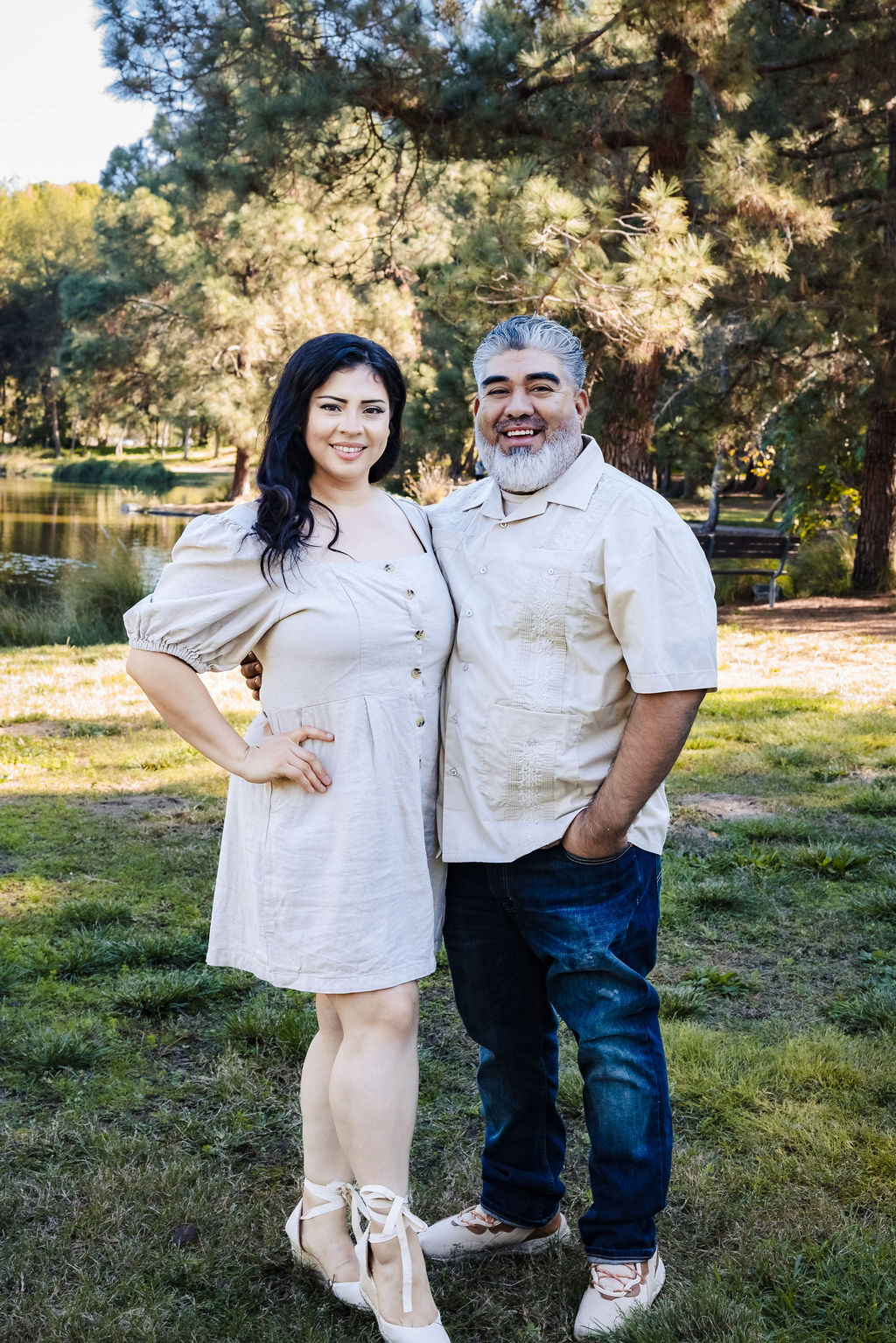 A husband and wife embracing outdoors