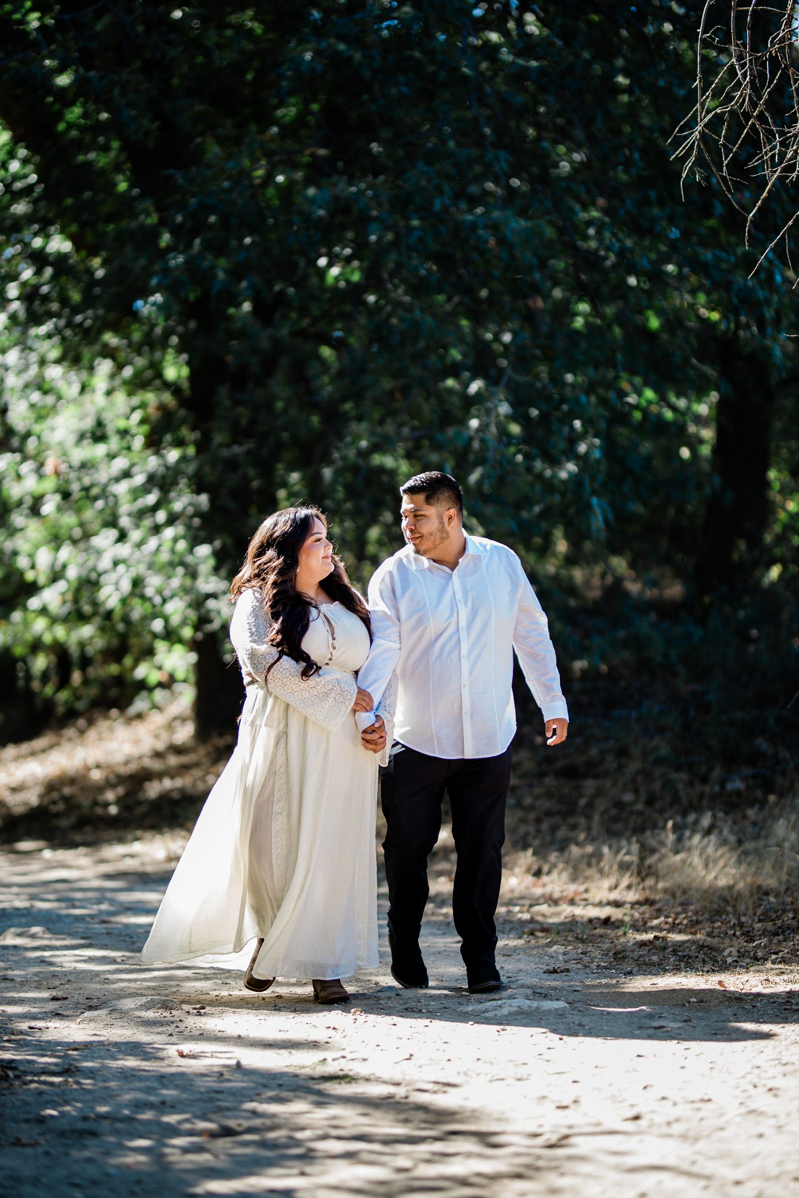 Eric and Cristina walking beneath the oaks at Oak Glen Preserve