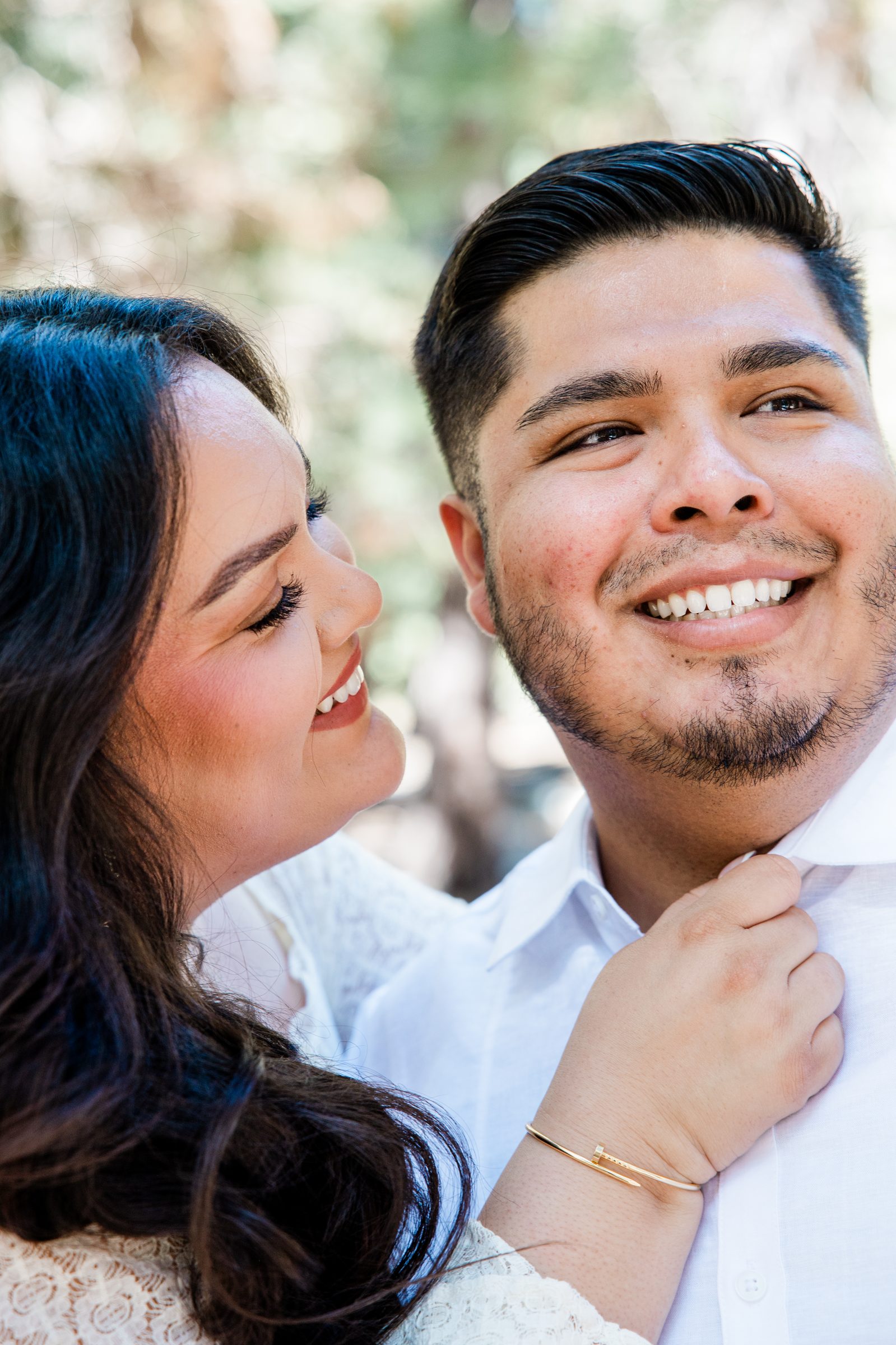 Close portrait of Cristina and Eric laughing together during their Oak Glen engagement session