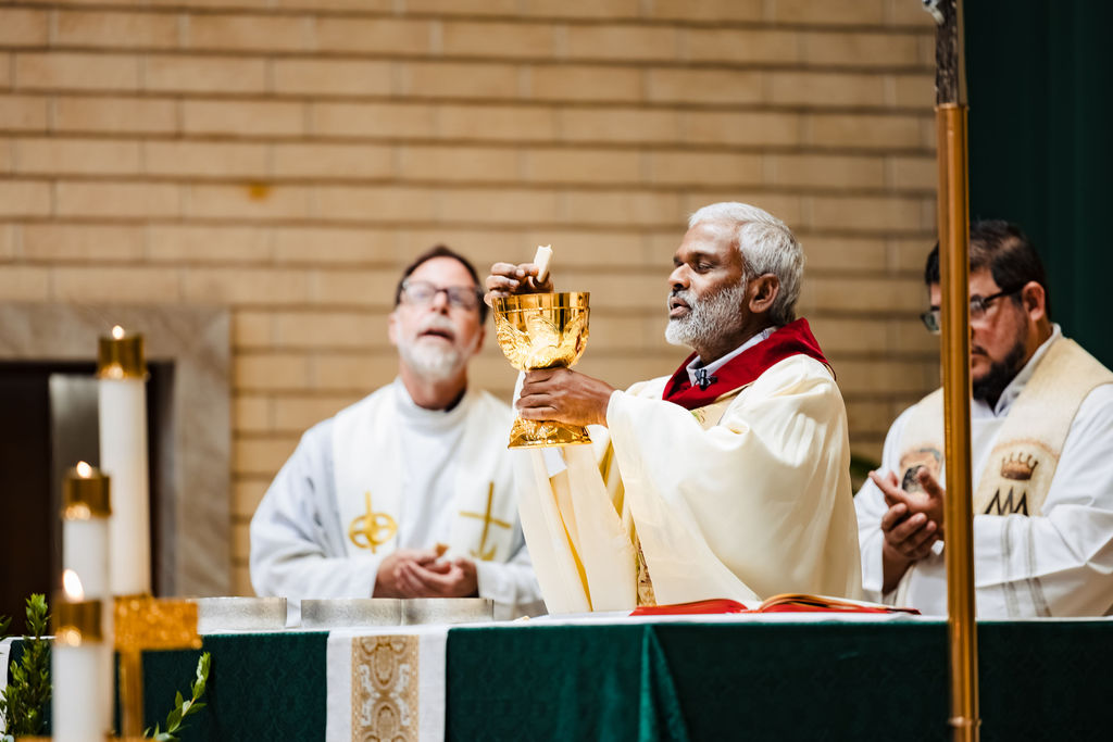 The priest elevating the chalice and host during the consecration at PJ and Sarah's Nuptial Mass, Saint Mary's Catholic Church, Fullerton