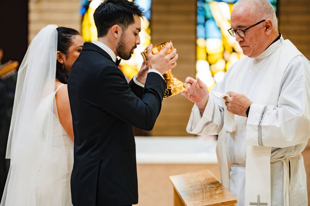 PJ approaching the altar to receive the chalice during his Nuptial Mass at Saint Mary's Catholic Church, Fullerton