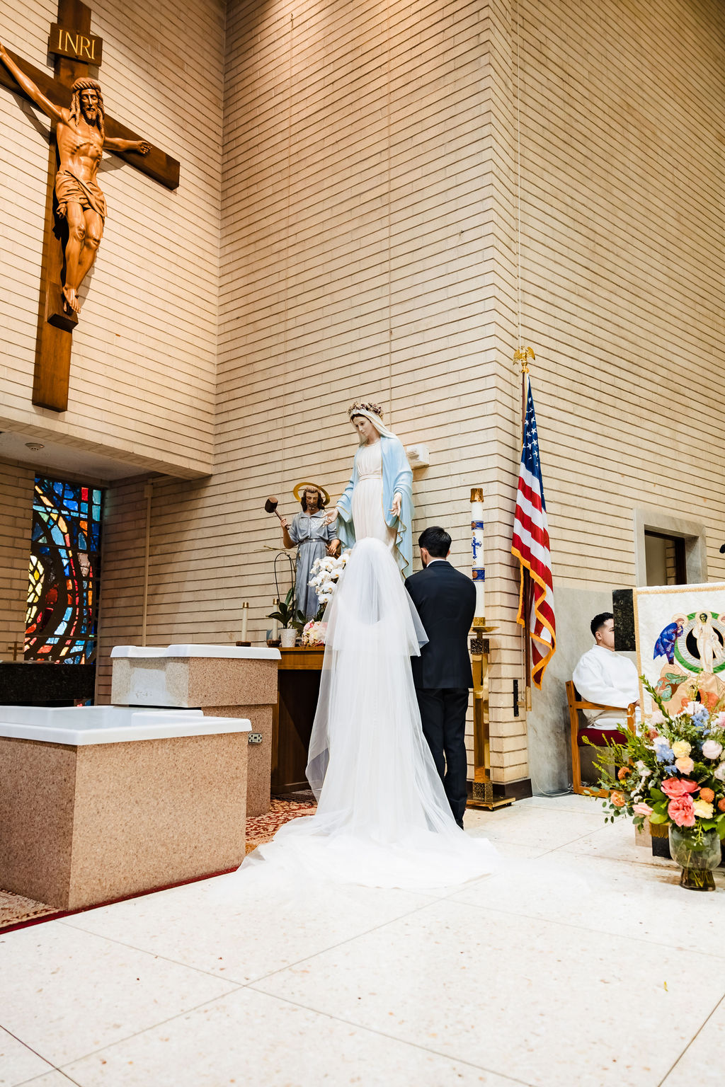 PJ and Sarah visiting the statue of the Virgin Mary after their wedding Mass at Saint Mary's Catholic Church, Fullerton