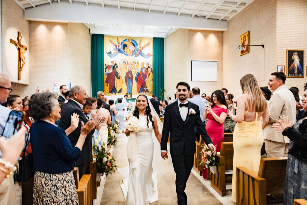 PJ and Sarah exiting Saint Mary's Catholic Church during their wedding recessional