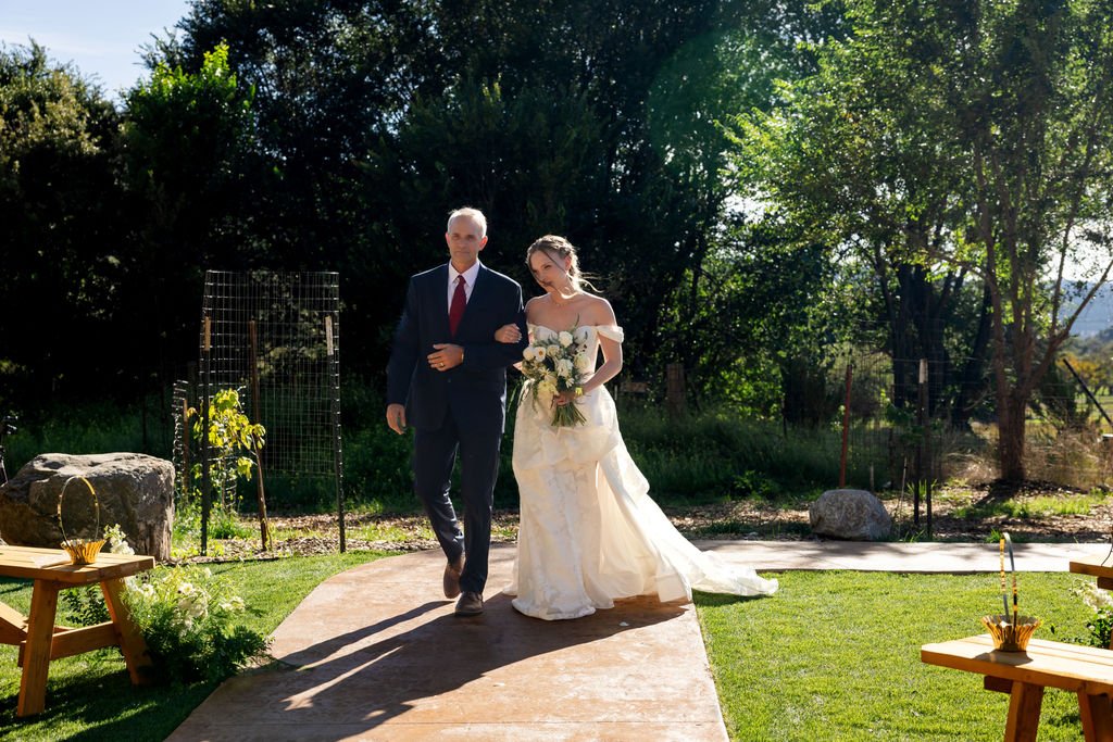 Aubrey and her father walking toward the ceremony at Aspen Falls
