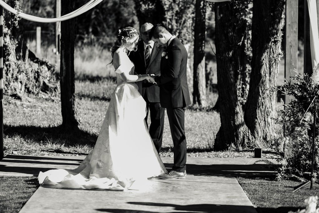 Black and white of the ring exchange beneath the trees