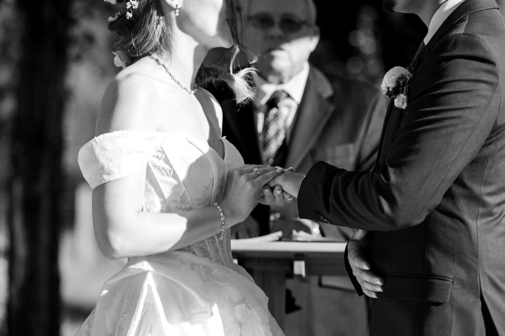Black and white close-up of the rings being exchanged