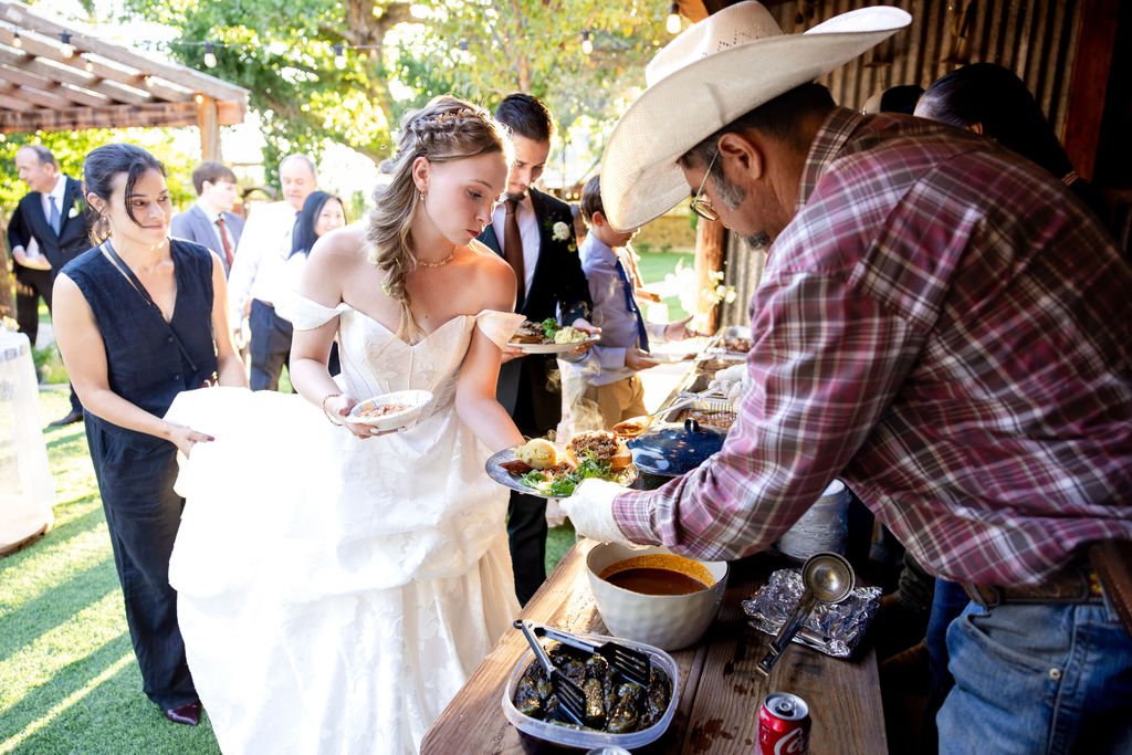 The bride at the reception buffet beneath the pavilion