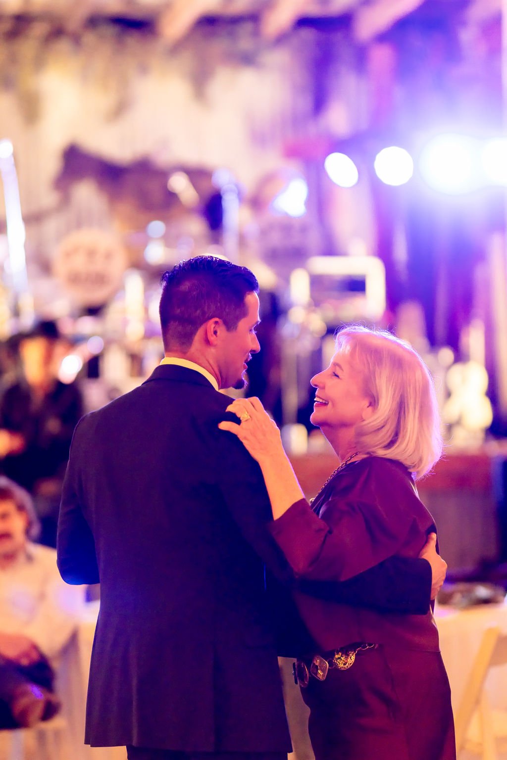 The groom sharing a dance under the stage lights