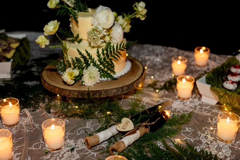 The wildflower wedding cake surrounded by candles