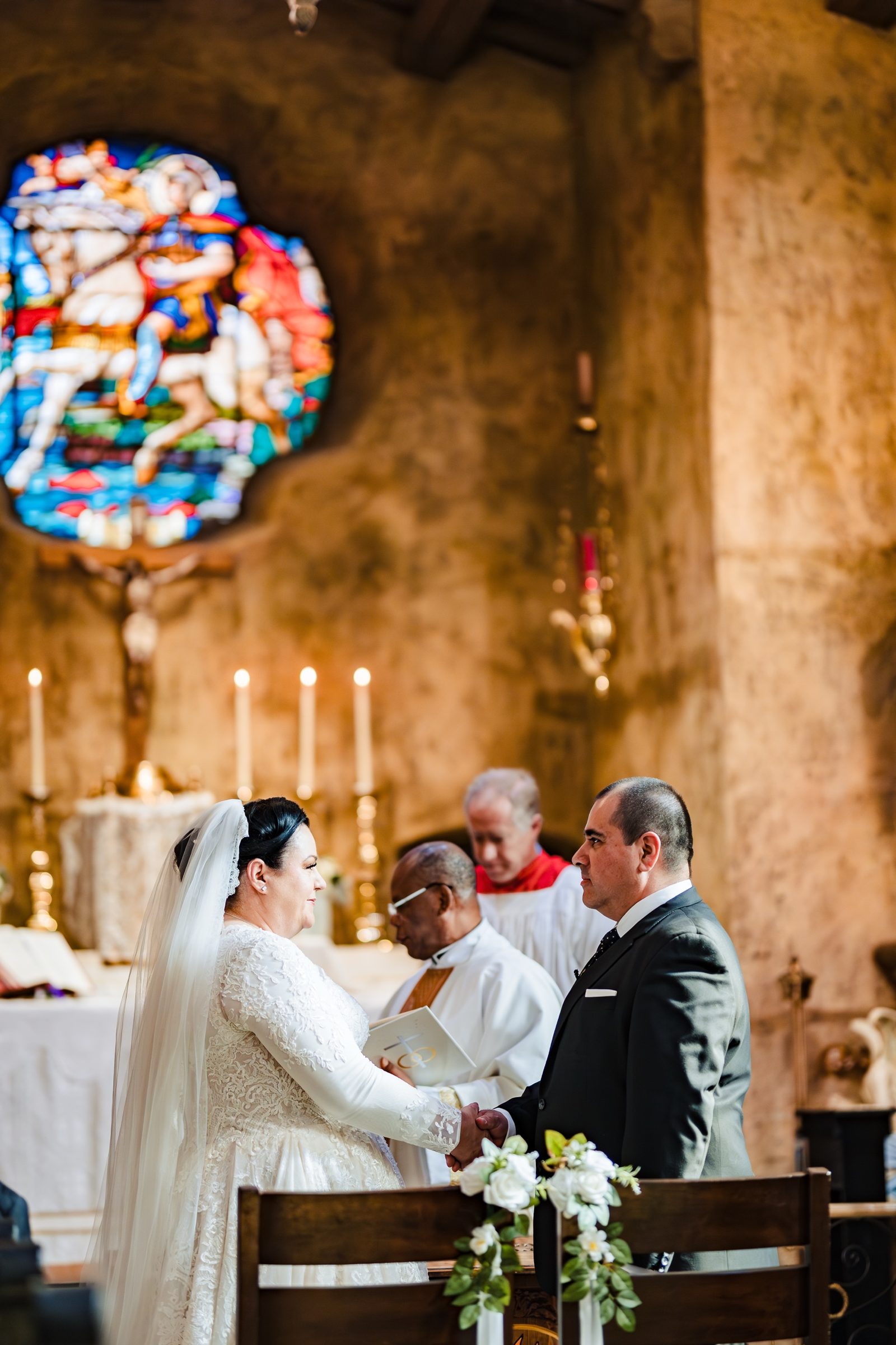 A bride and groom exchanging vows beneath the stained glass of San Secondo d'Asti, Ontario