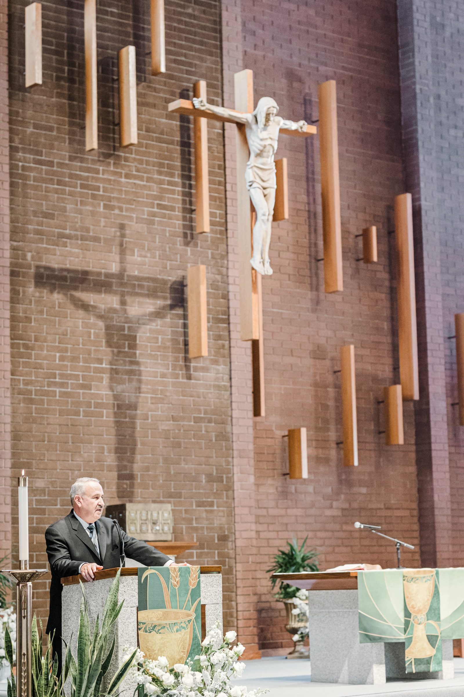 A reader at the ambo beneath the crucifix at St. Angela Merici