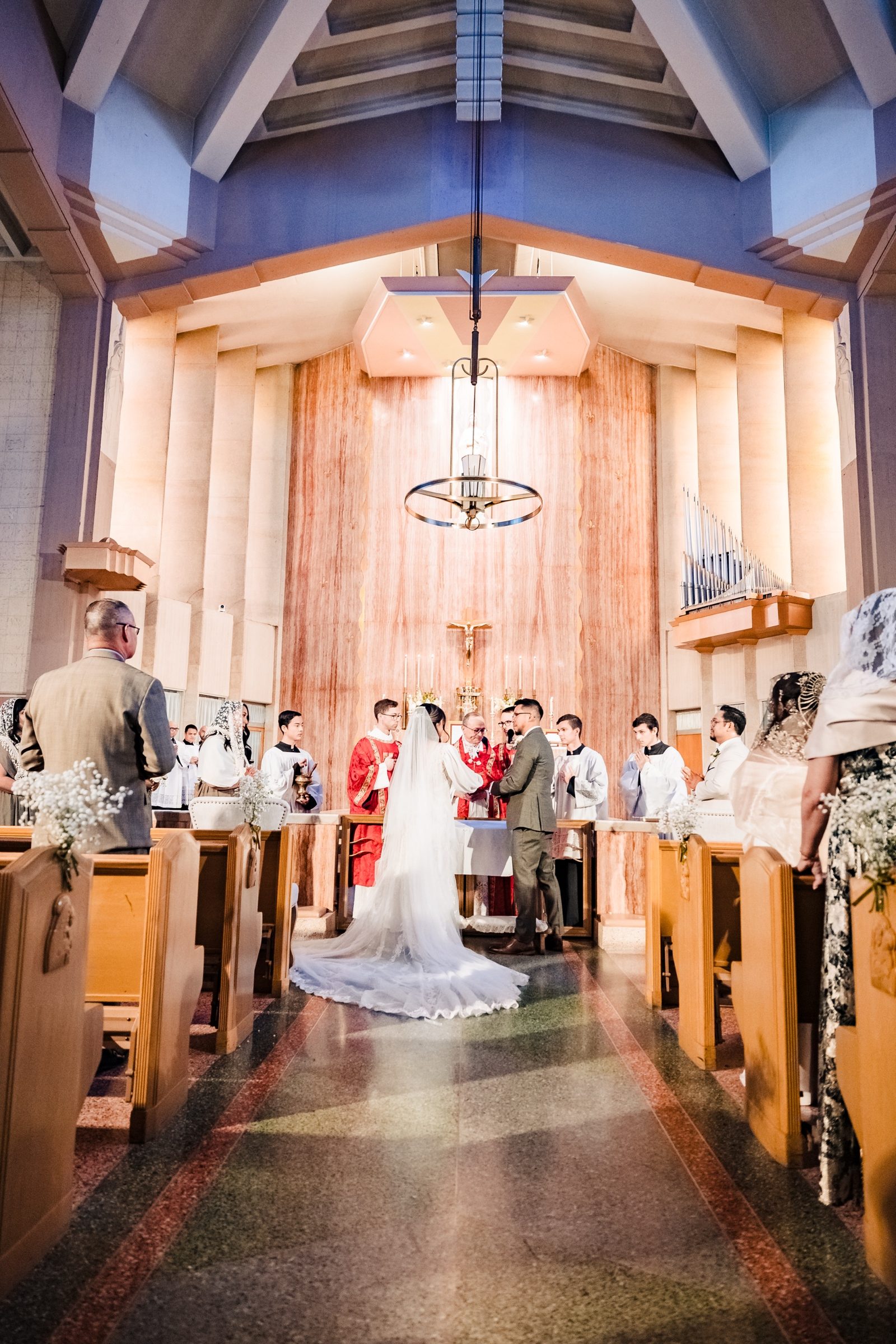 The exchange of vows before the rose marble sanctuary of St. Therese, Alhambra