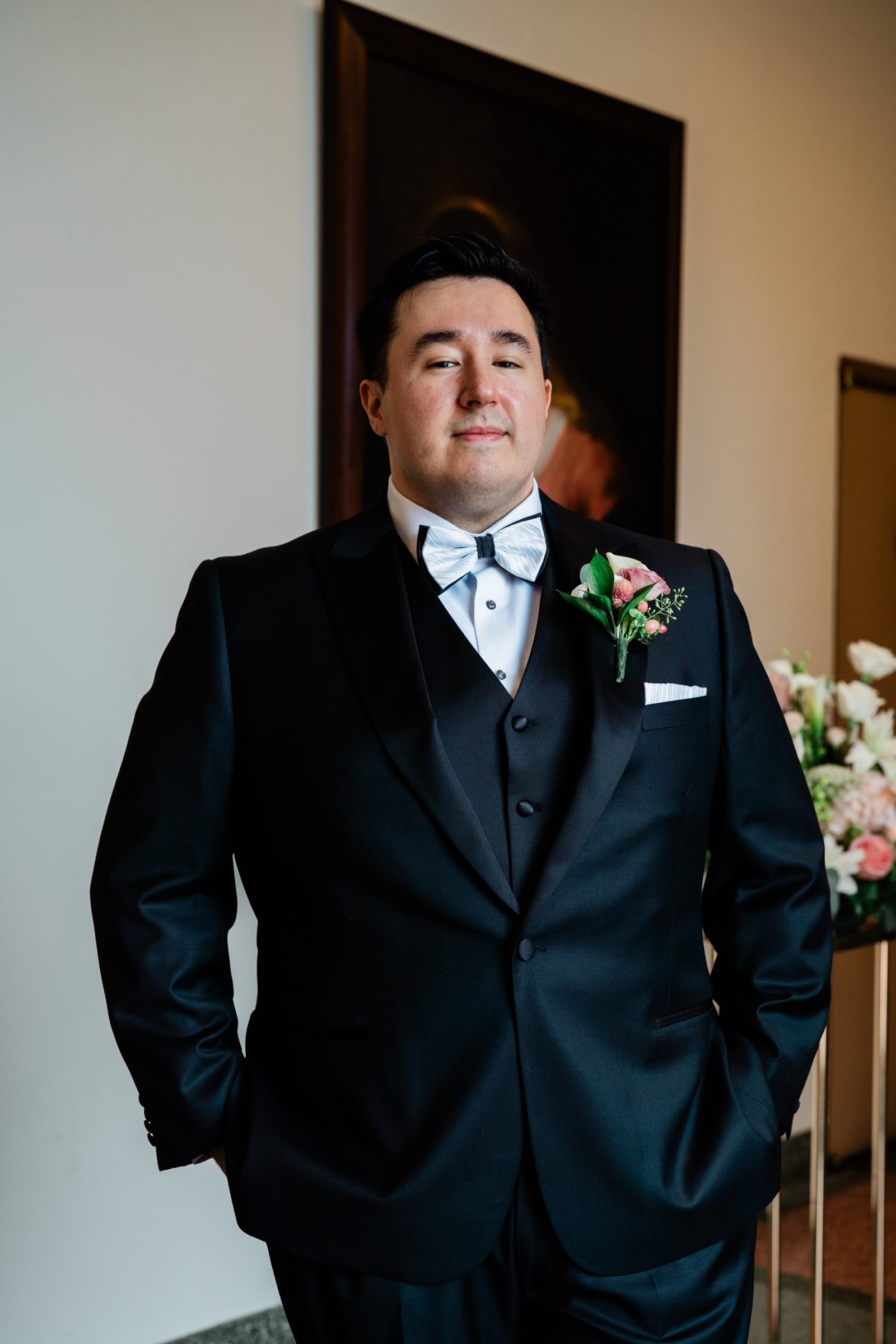 Groom portrait in a navy tuxedo and bow tie