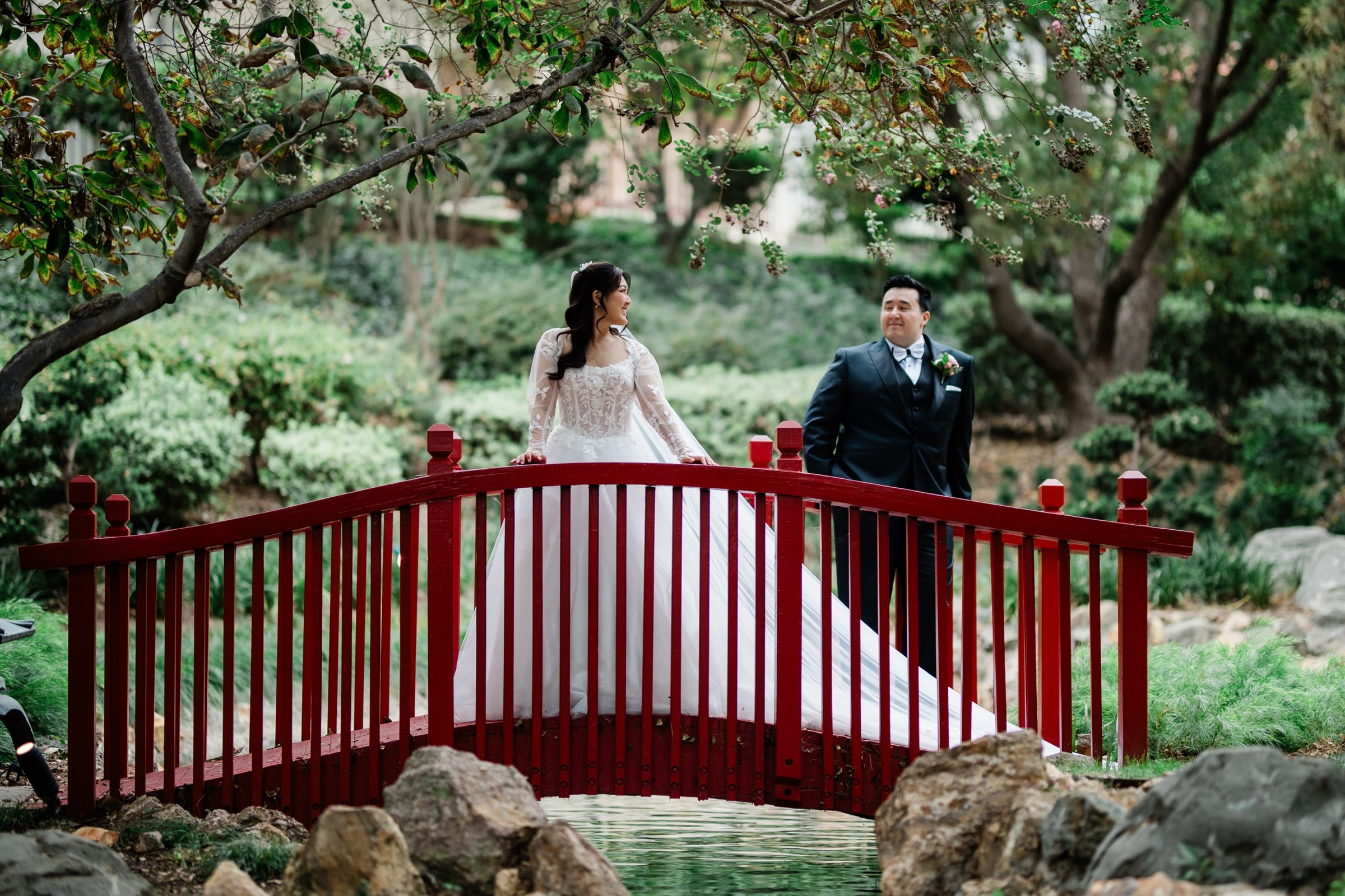 Andrew and Candice on a red garden bridge at the Langham Huntington, Pasadena