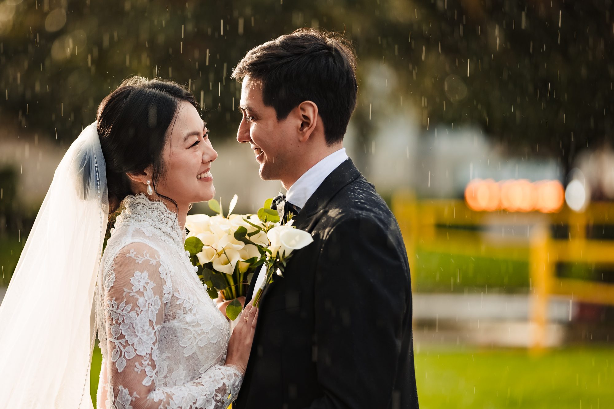Golden hour kiss in the rain, backlit by the setting sun