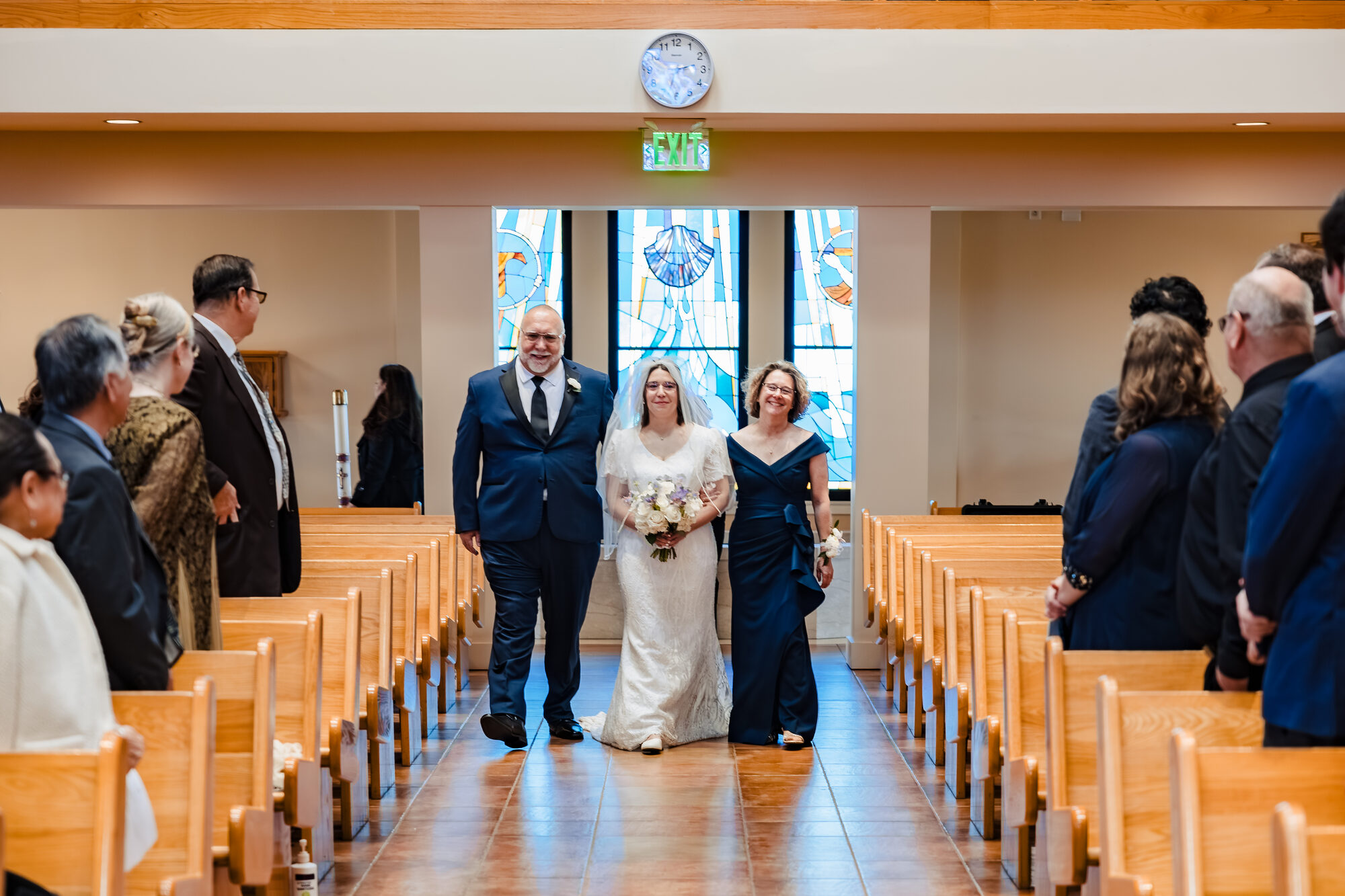 Bride walked down the aisle by both parents during the Catholic wedding in Hermosa Beach