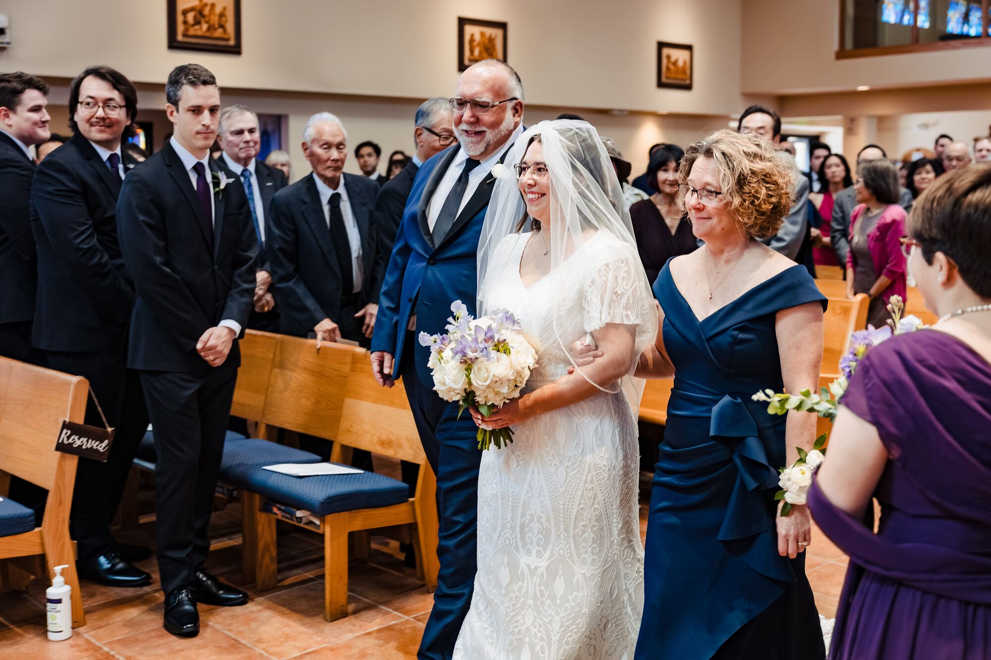 Brett and Kristen at the altar during the Nuptial Mass beneath the rose window