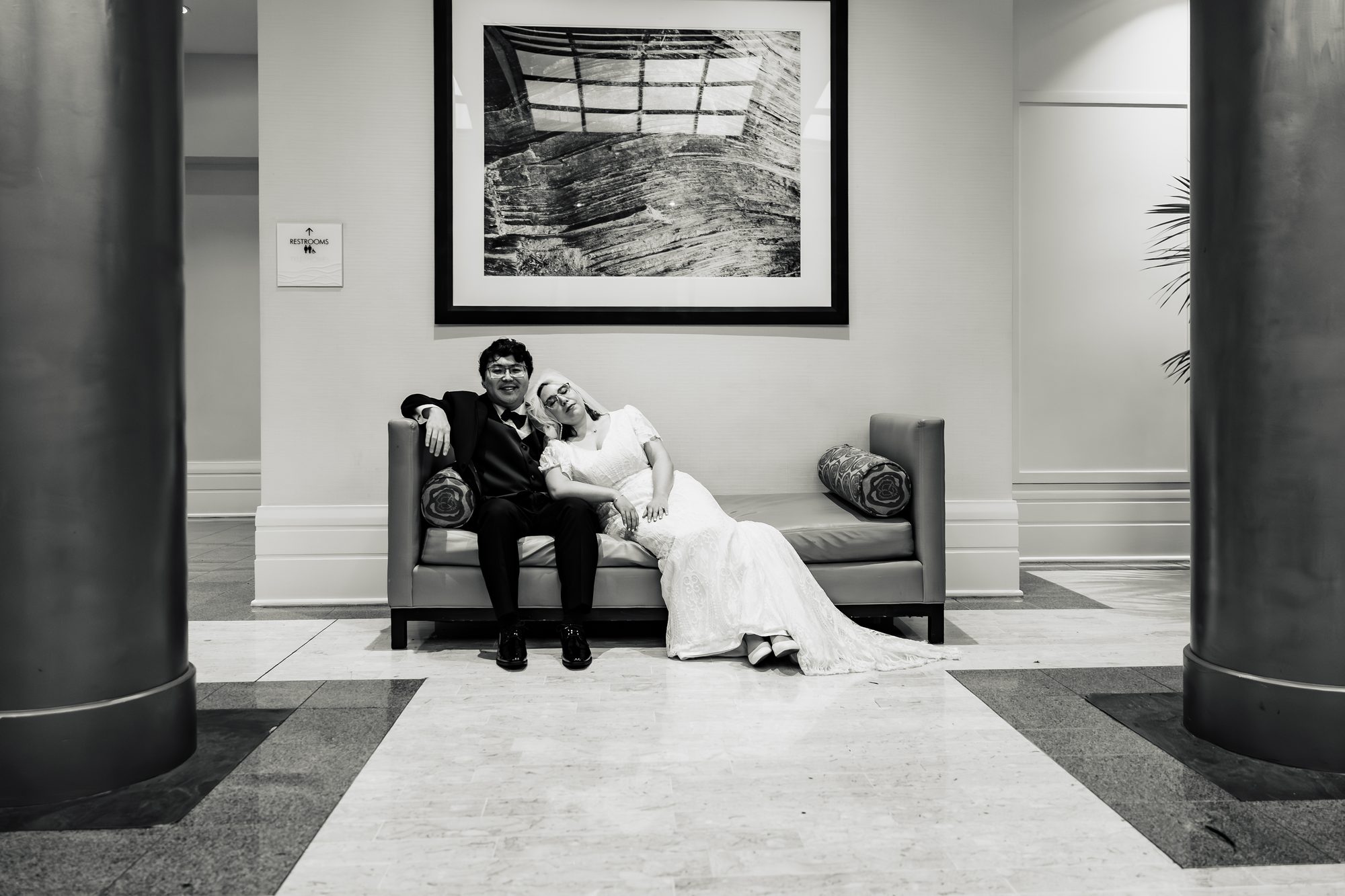 Black and white portrait of the newlyweds resting on a lounge at the Sonesta