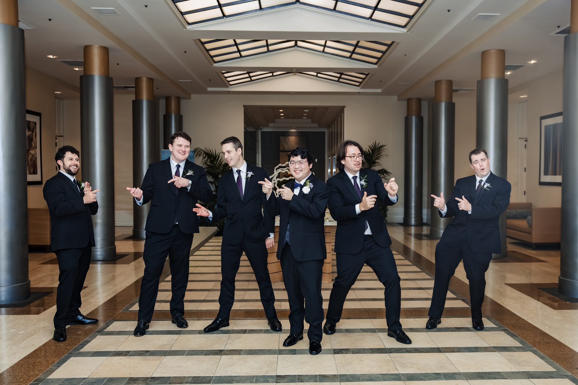 Groomsmen group portrait at the Sonesta hotel before the reception