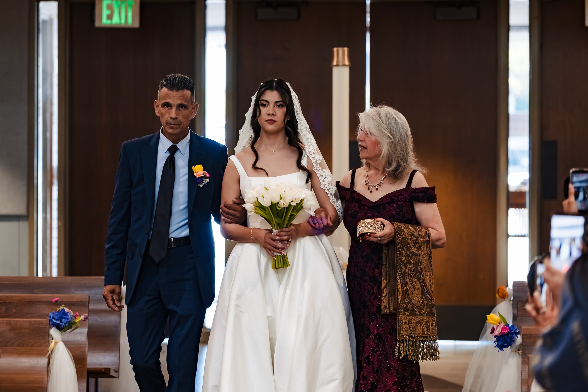 Judith escorted down the aisle by her father and mother