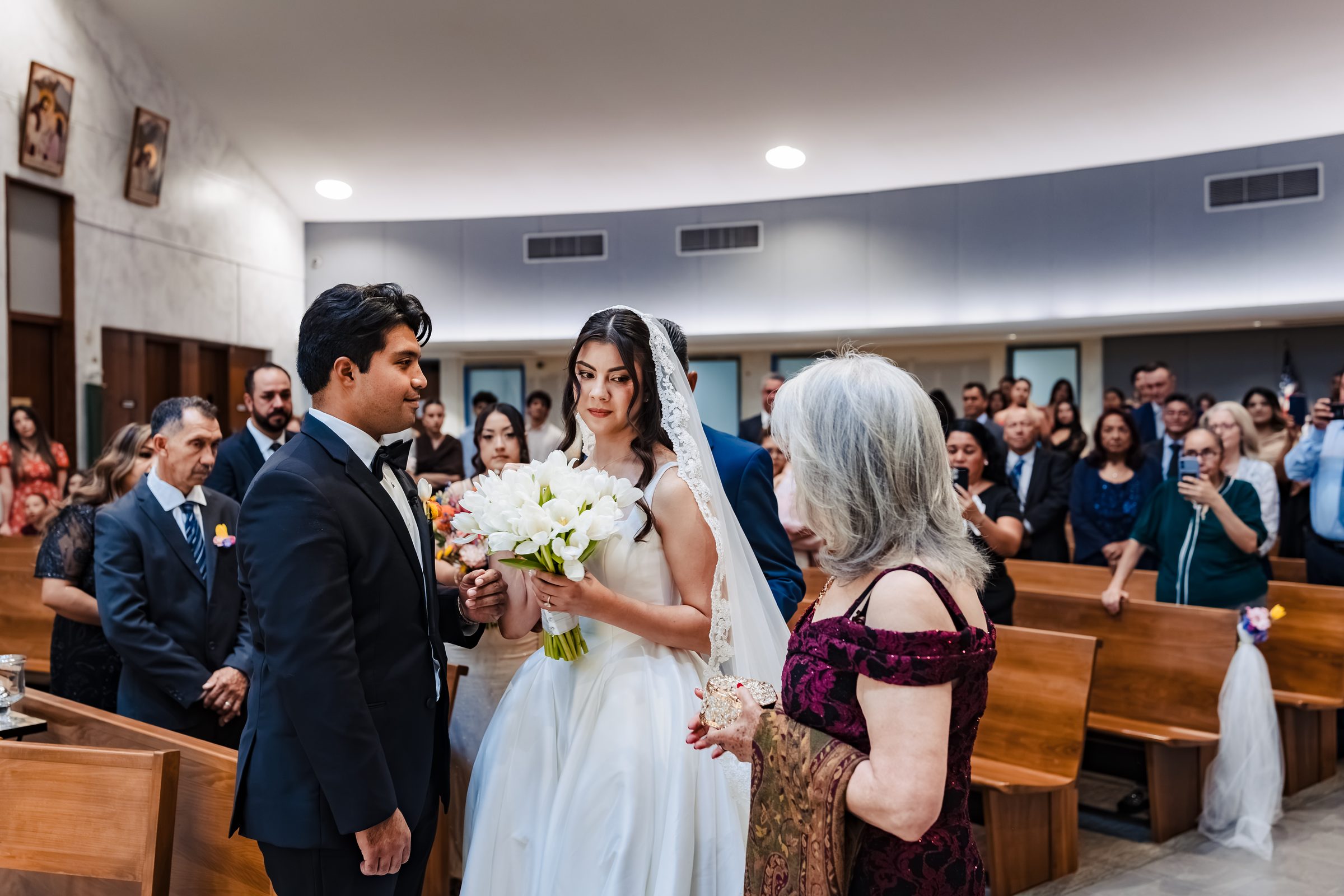 Judith's parents giving her to Diego at the front of the church