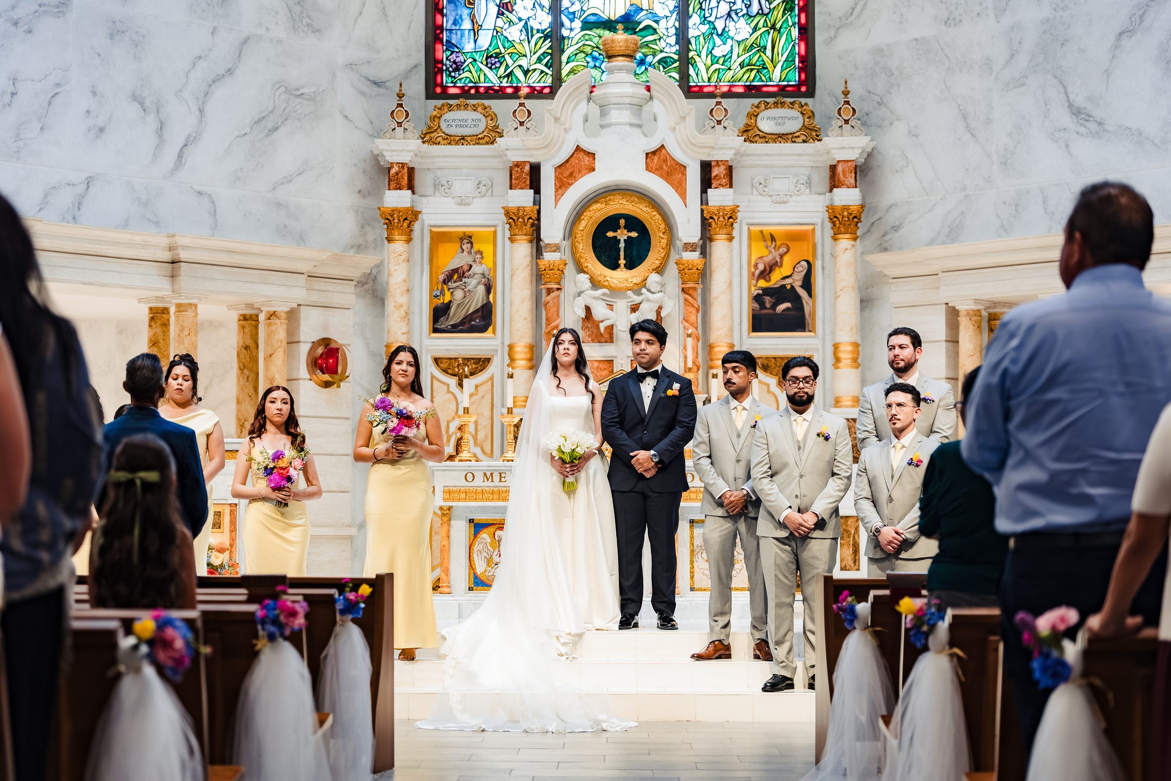 The couple and wedding party before the gilded high altar at Saint Martin de Porres