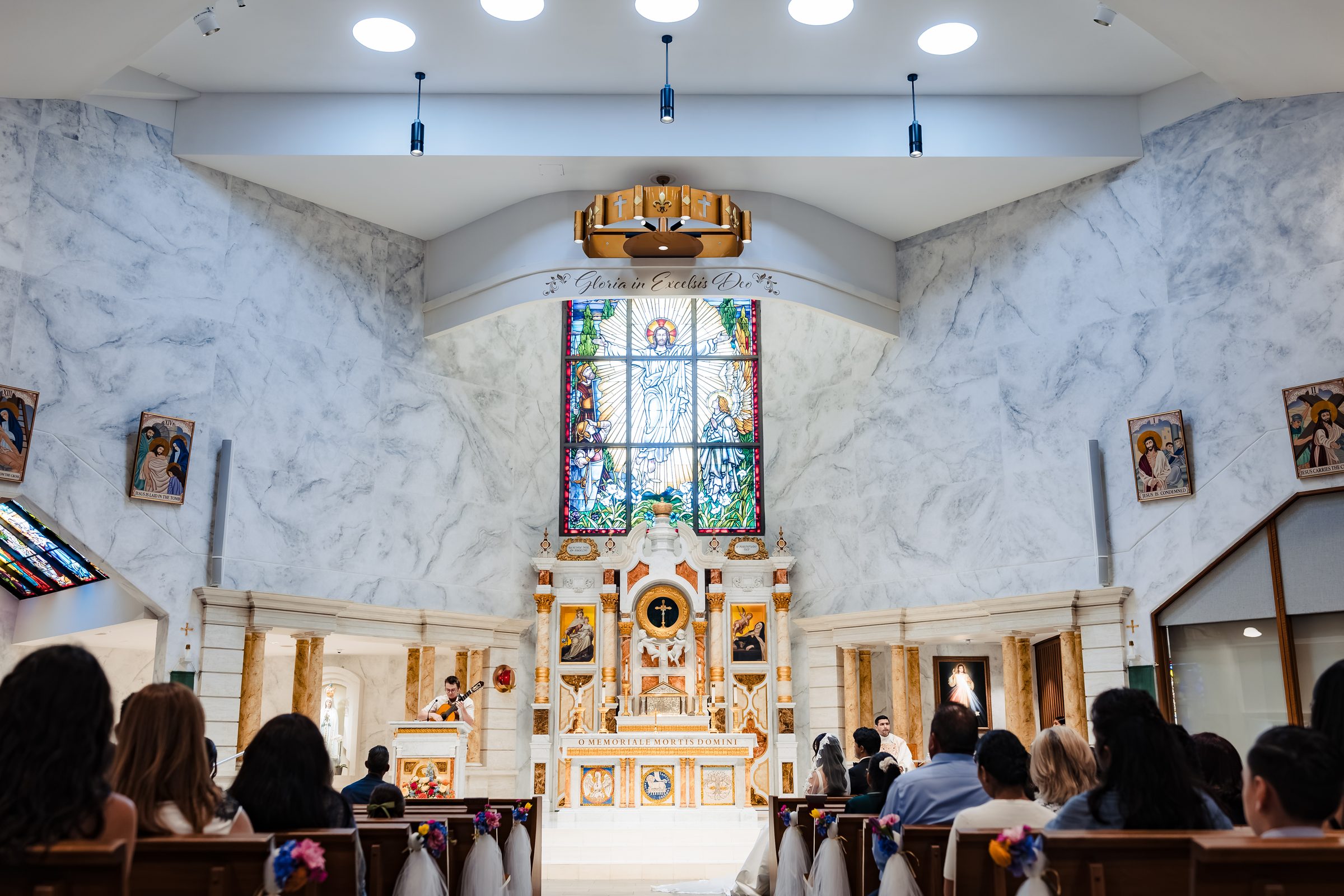 Wide view of the sanctuary and stained glass at Saint Martin de Porres