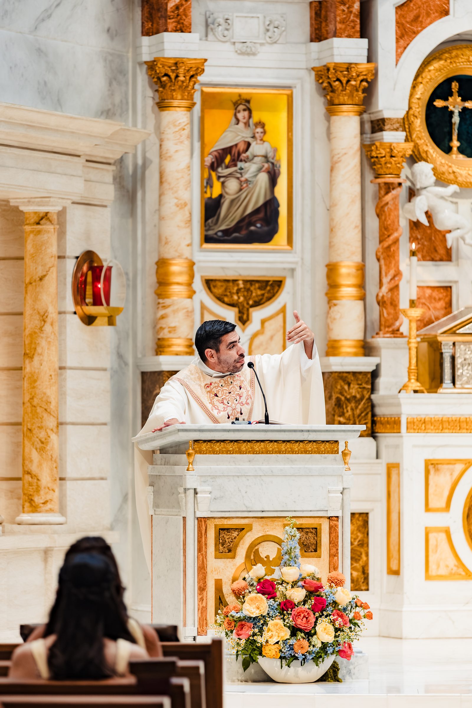 The homily from the ambo before the ornate high altar